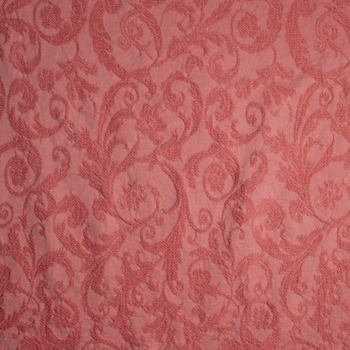 Poppy: A close up of Adele fabric in poppy, a warm coral pink.