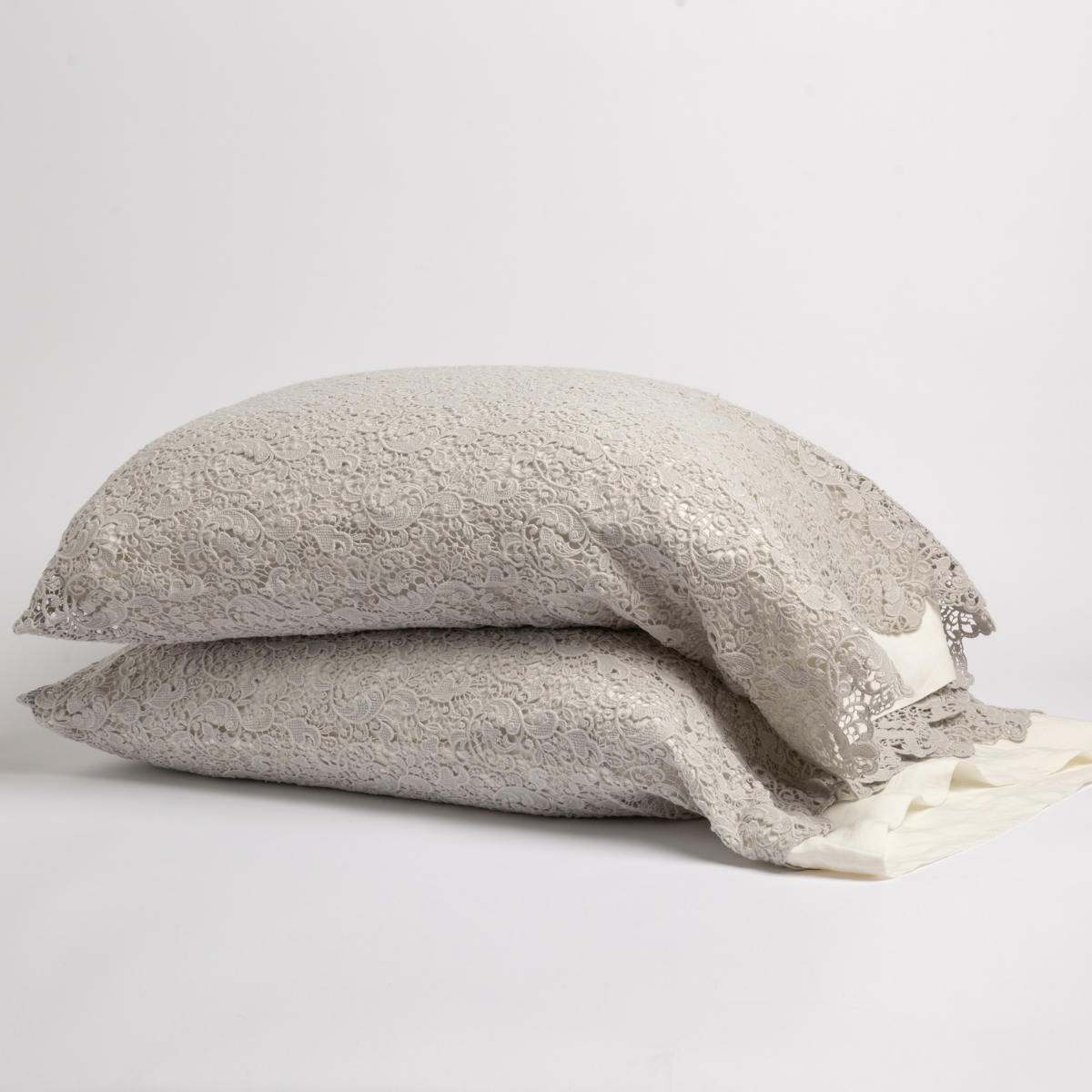 Cloud: a pair of stacked cotton lace pillowcase covers on winter white liners against a white background.