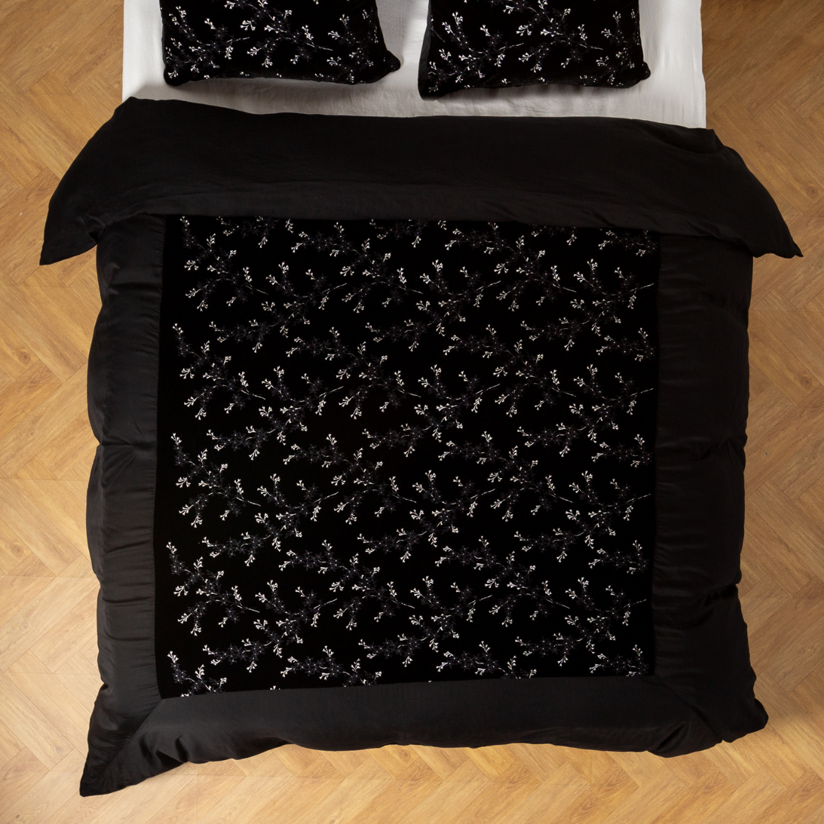 Corvino: An overhead shot of an embroidered silk velvet and tencel duvet cover and matching shams.