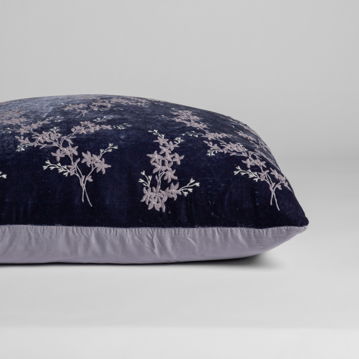 French Lavender: A close-up of the sham shown on its side to display the embroidered silk velvet face and tencel back — shown against a white background.