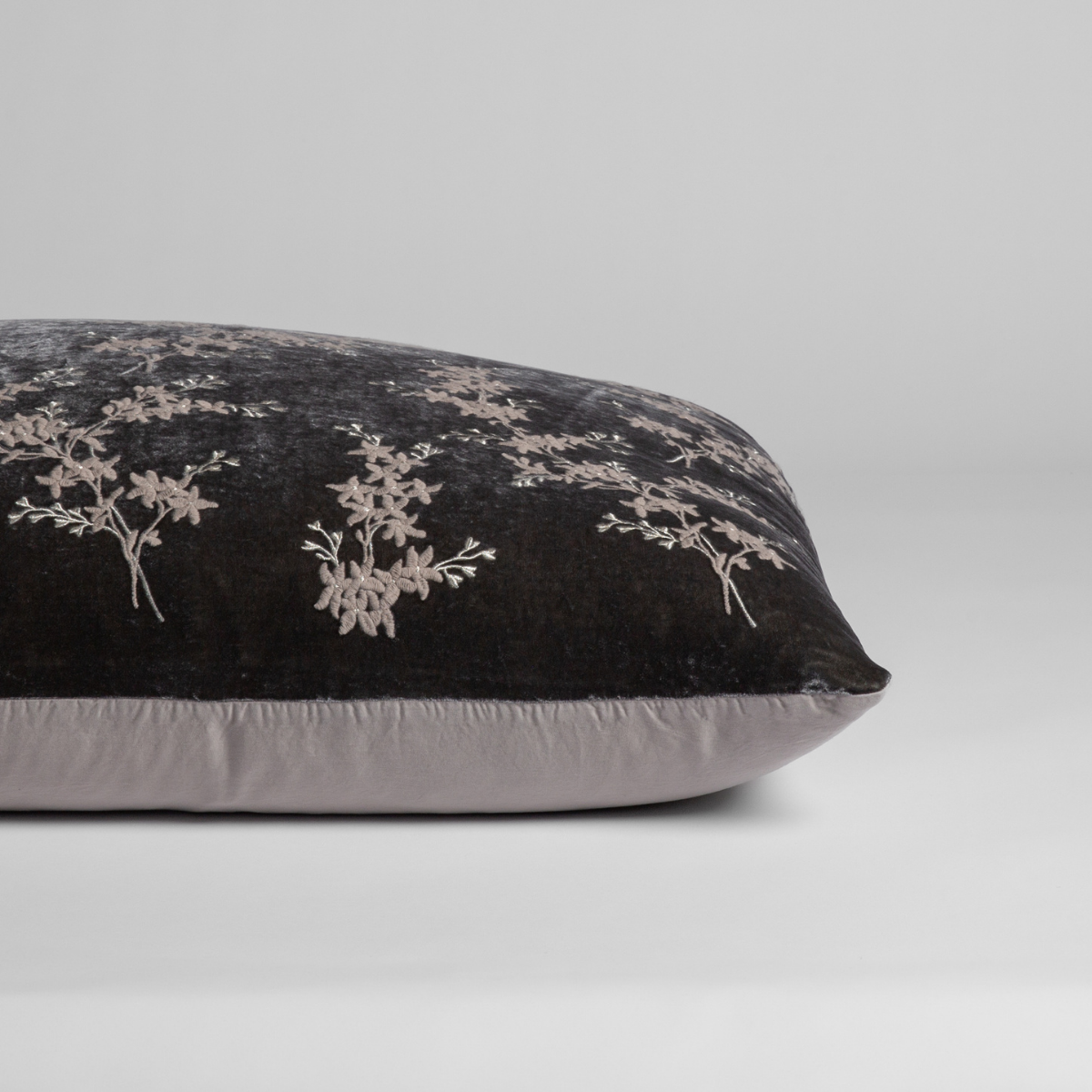 Moonlight: A close-up of the sham shown on its side to display the embroidered silk velvet face and tencel back — shown against a white background.