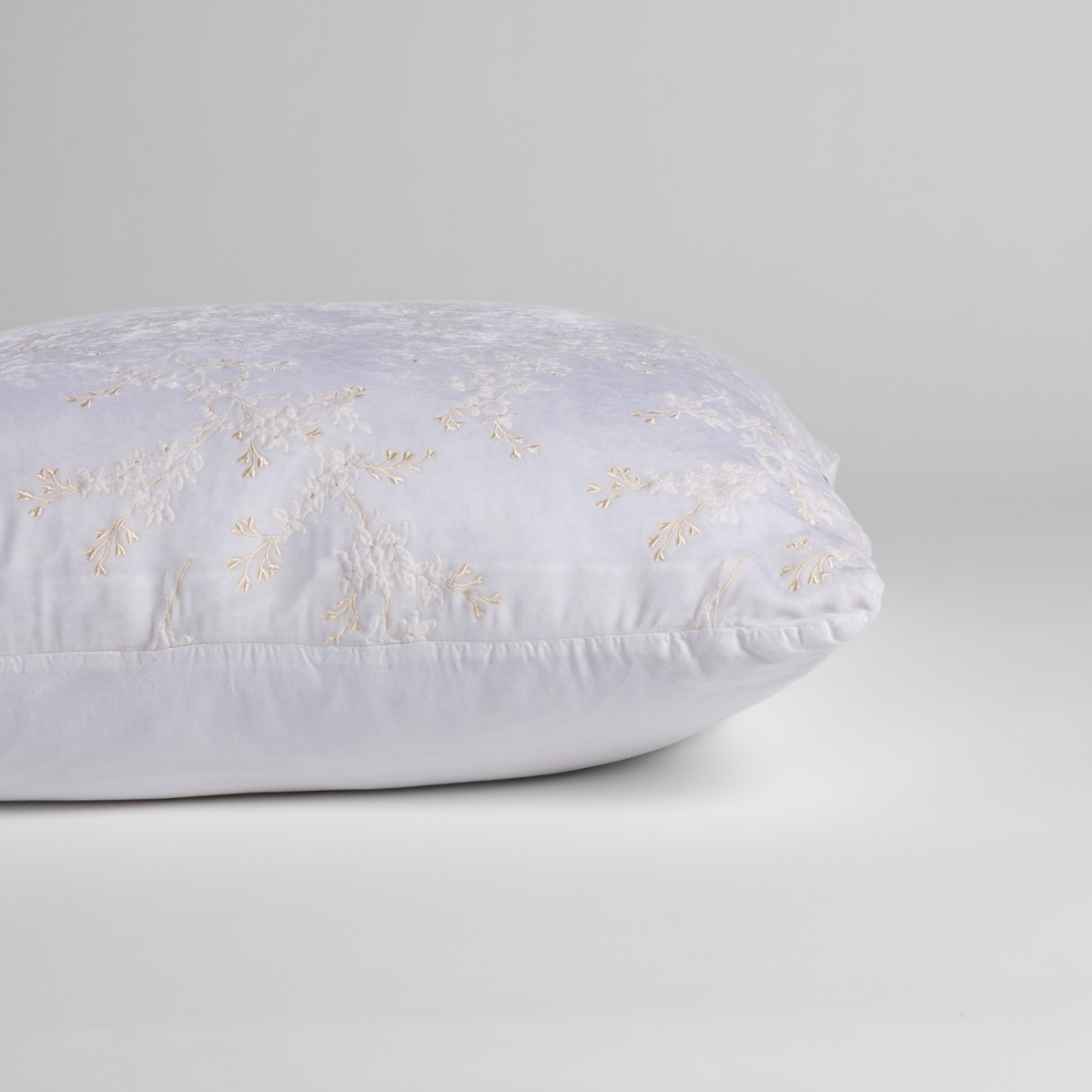 White: A close-up of the sham shown on its side to display the embroidered silk velvet face and tencel back — shown against a white background.