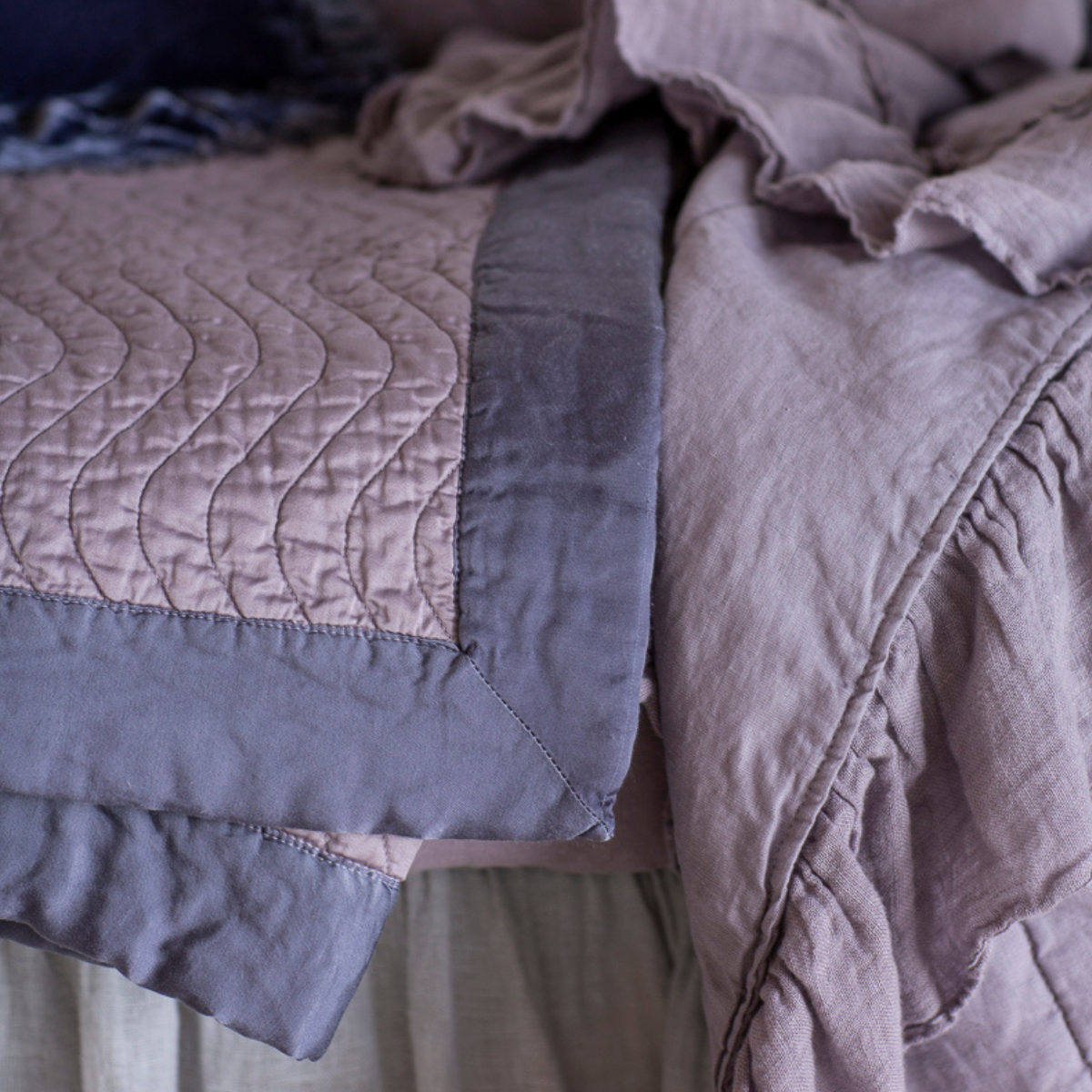 : a close up of quilted cotton sateen baby blanket and linen whisper baby blanket both in French Lavender.