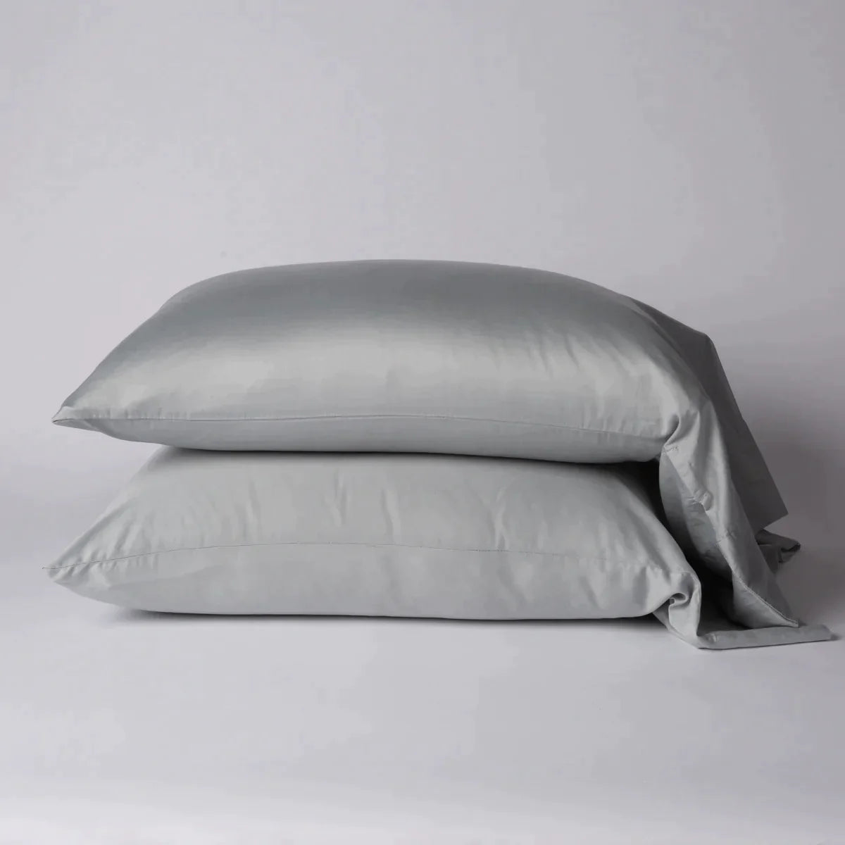 Mineral: Two cotton sateen sleeping pillows, stacked neatly against a white backdrop - side view.