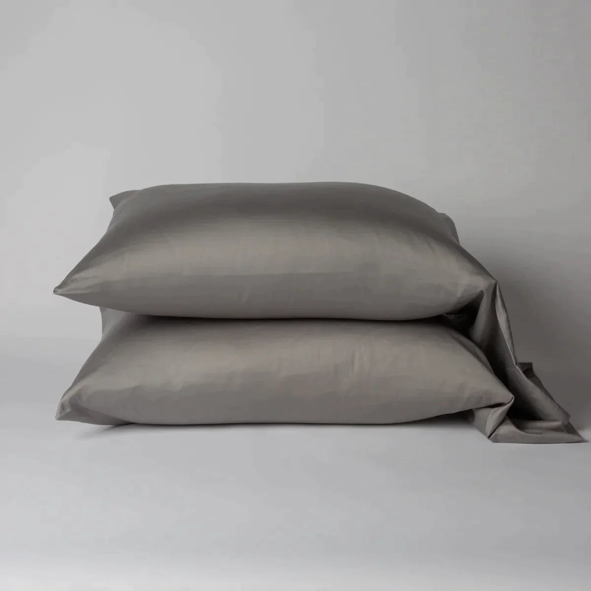 Moonlight: Two cotton sateen sleeping pillows, stacked neatly against a white backdrop - side view.