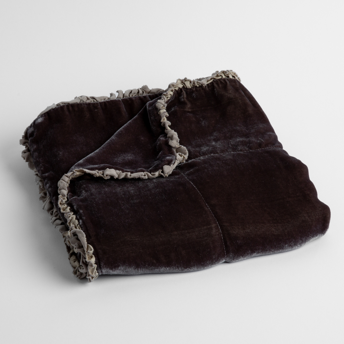 Moonlight: silk velvet baby blanket with charmeuse trim shown slightly overhead with a corner folded back to show trim detail against a white background.