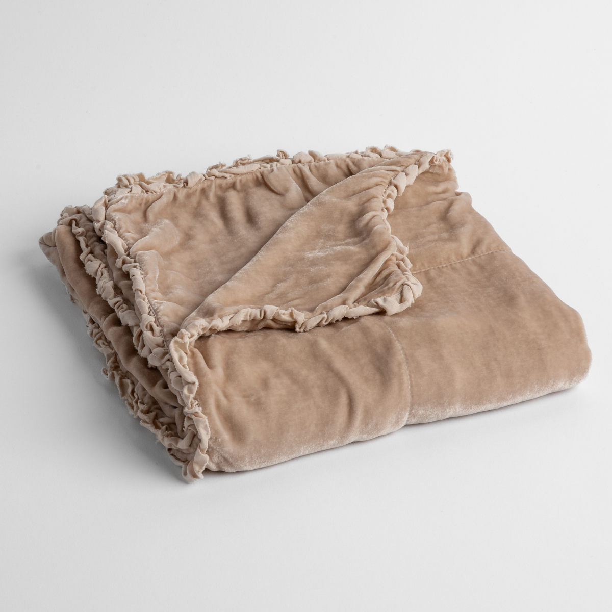 Pearl: silk velvet baby blanket with charmeuse trim shown slightly overhead with a corner folded back to show trim detail against a white background.