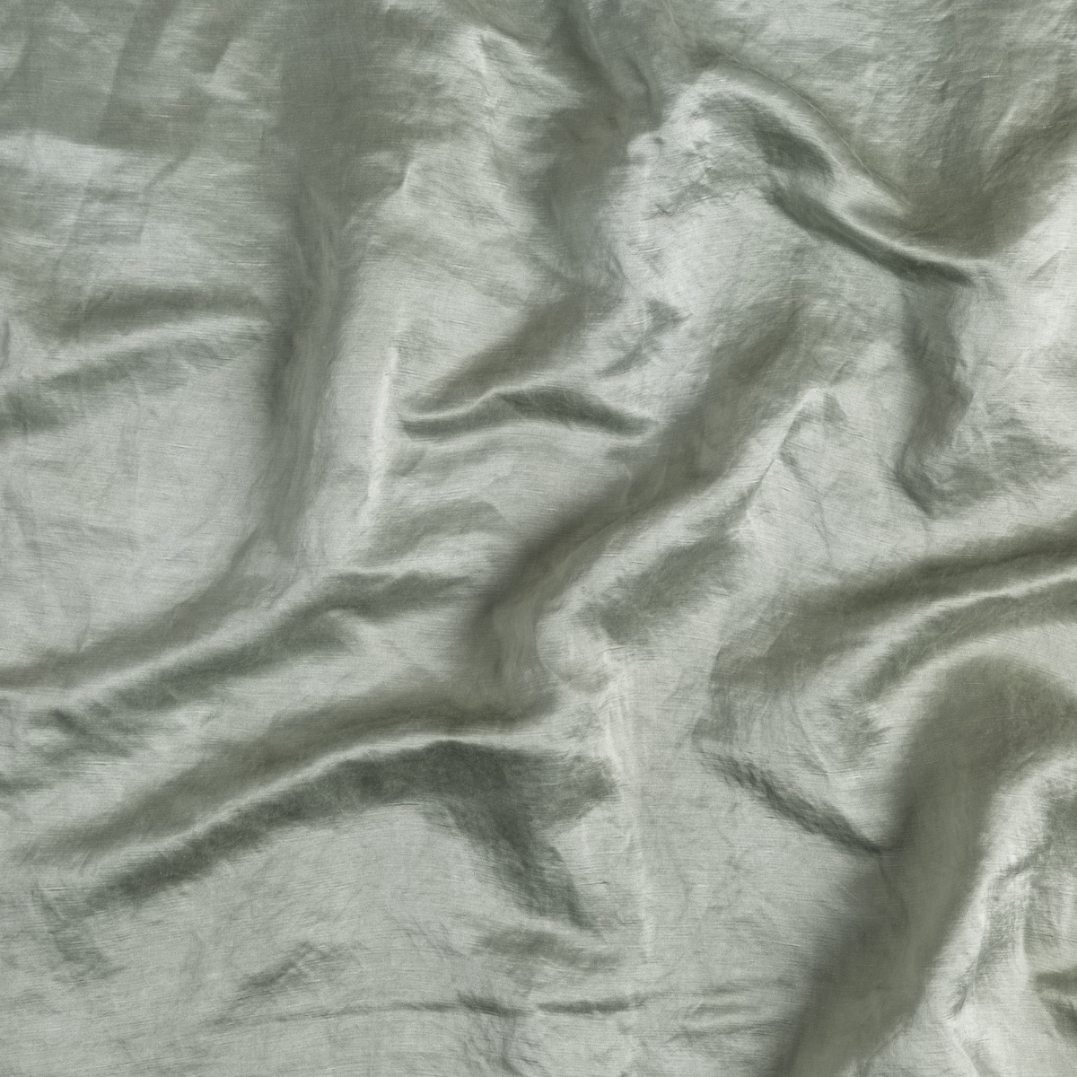 Mineral: A close up of charmeuse fabric in mineral, a soothing seafoam blue with subtle grey-green undertones.