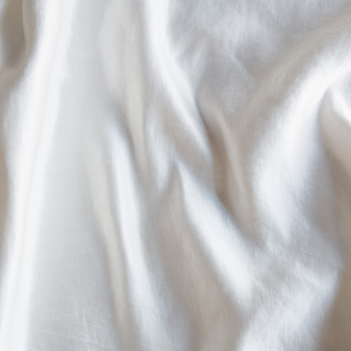 Winter White: A close up of charmeuse fabric in winter white, softer and warmer in tone than classic white.