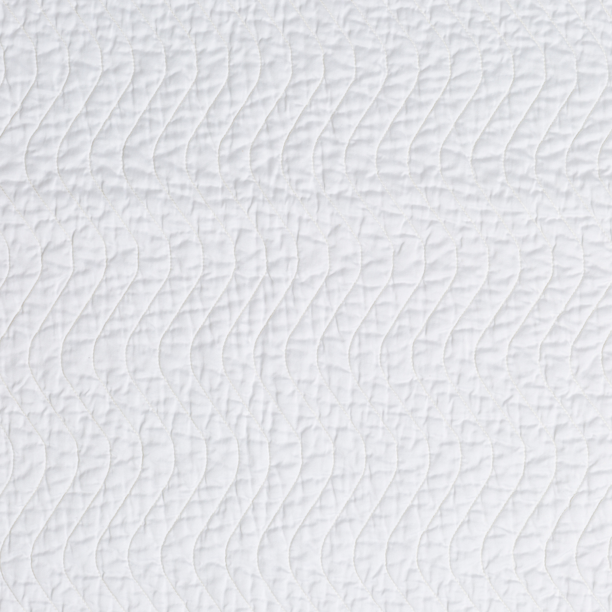 White: A close up of quilted cotton sateen fabric in classic white.