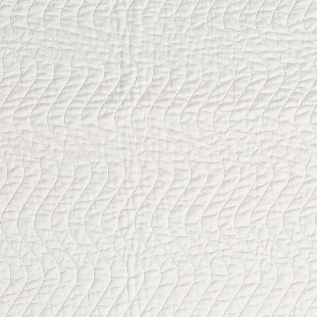 Winter White: A close up of quilted cotton sateen fabric in winter white, softer and warmer in tone than classic white.