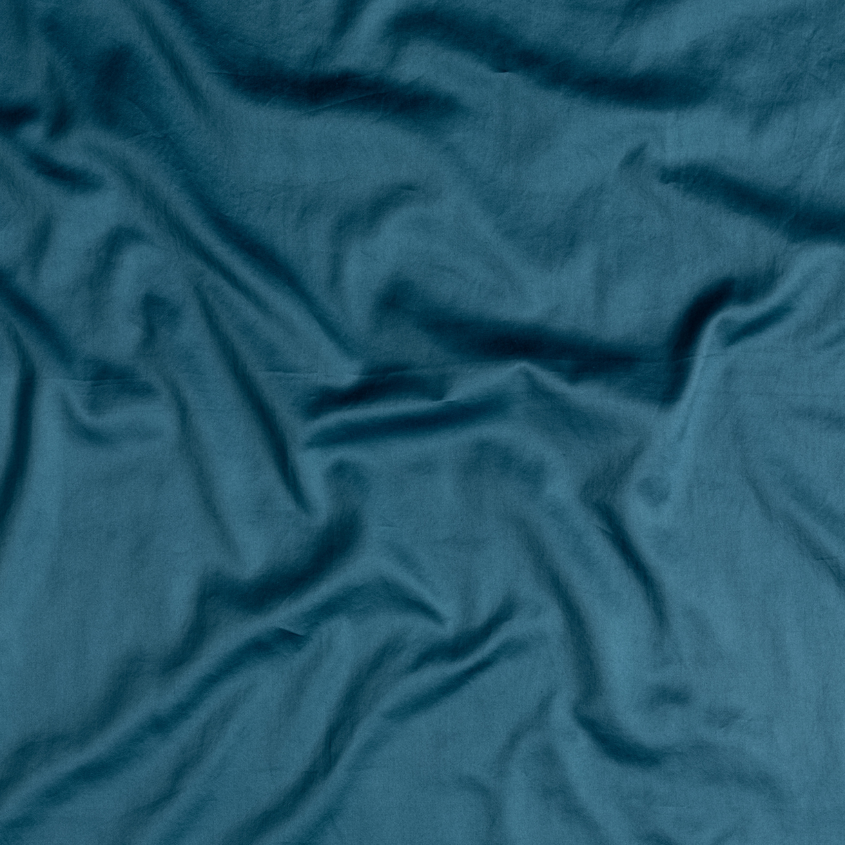 Cenote: A close up of cotton sateen fabric in cenote, a vibrant, ocean-inspired blue-green.