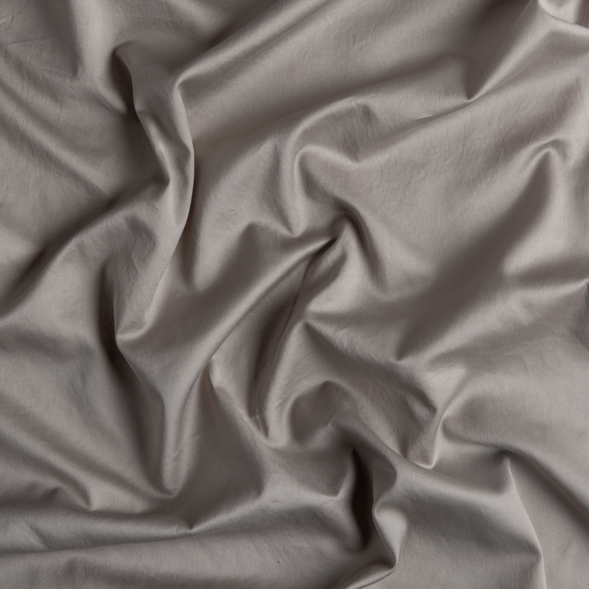 Fog: A close up of cotton sateen fabric in fog, a neutral-warm, soft mid-tone grey.