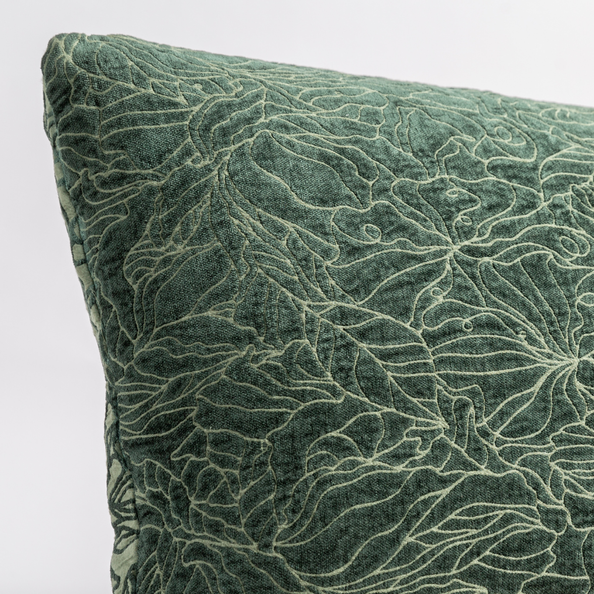 Juniper: close up of the chenille jacquard corner of a pillow cushion with a single-line floral pattern.