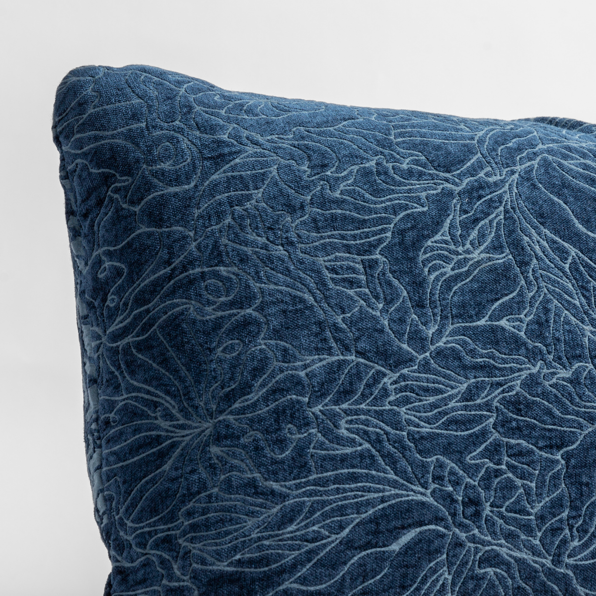 Midnight: close up of the chenille jacquard corner of a pillow cushion with a single-line floral pattern.