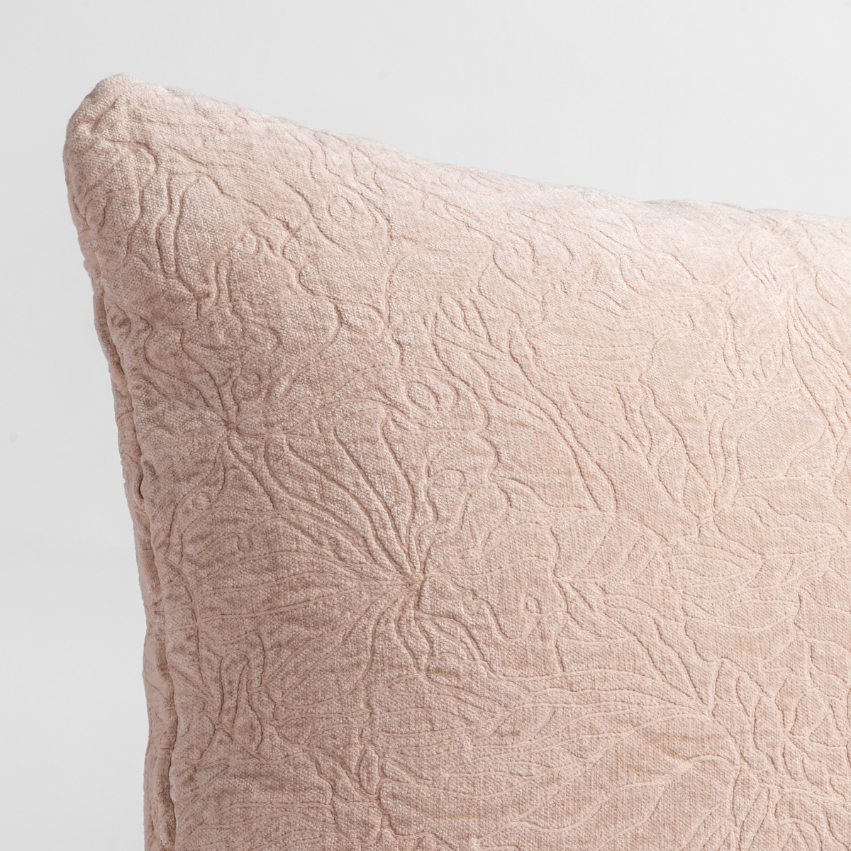 Pearl: close up of the chenille jacquard corner of a pillow cushion with a single-line floral pattern.