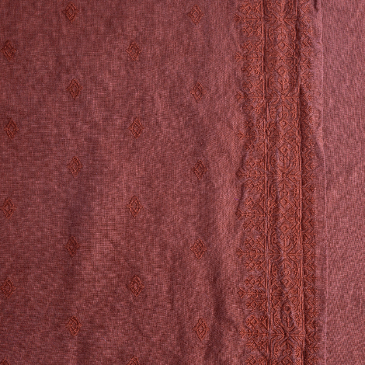 Autumn: Bella Notte Linens Embroidered Midweight Linen in Autumn, a rich rust-tone, close up to show the embroidery patterns.