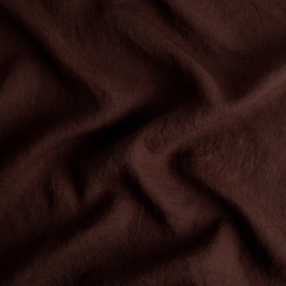 A close up of linen in mahogany, a deep, earthen, reddish brown.