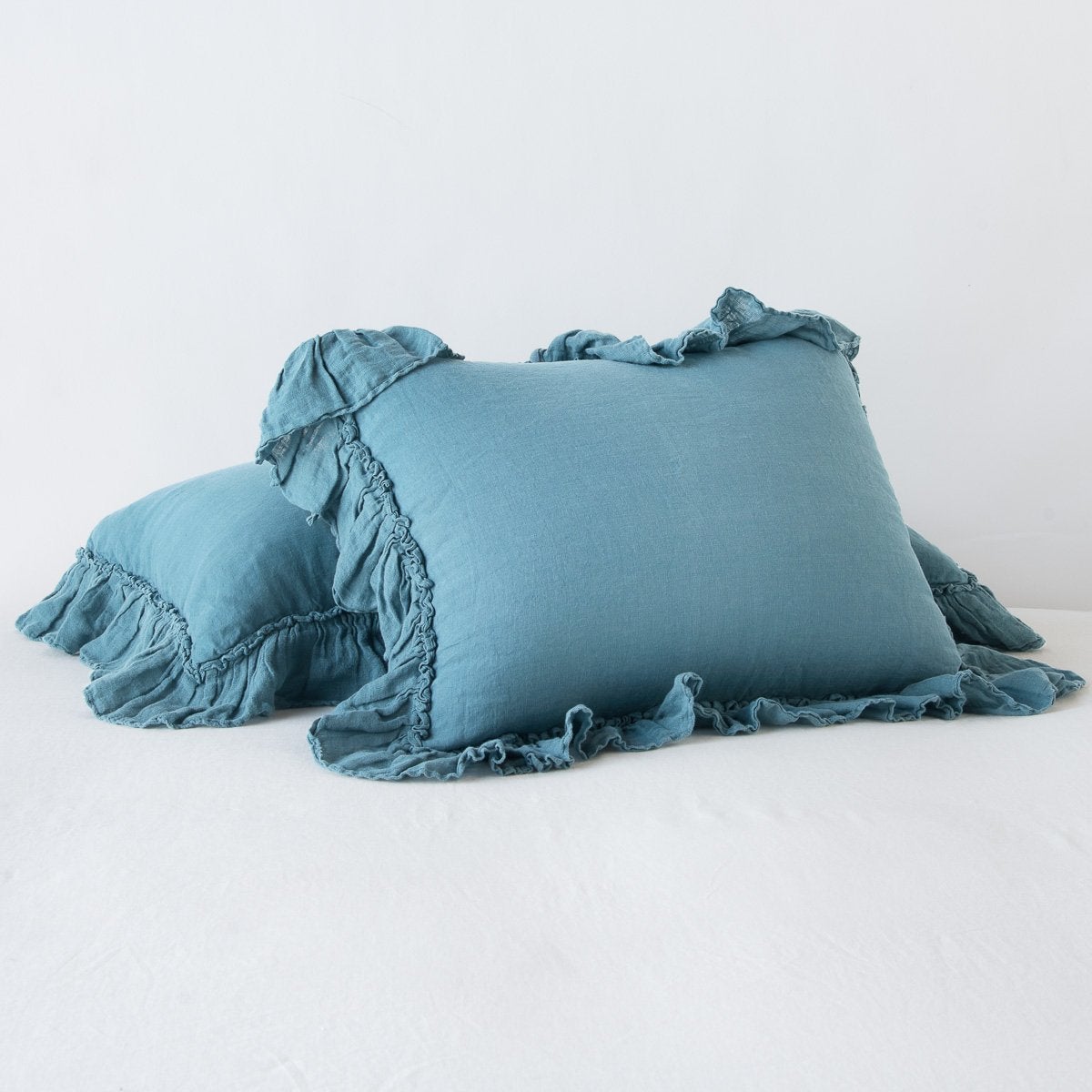 Cenote: standard sham leaning against a king sham laying flat, on a plain background.