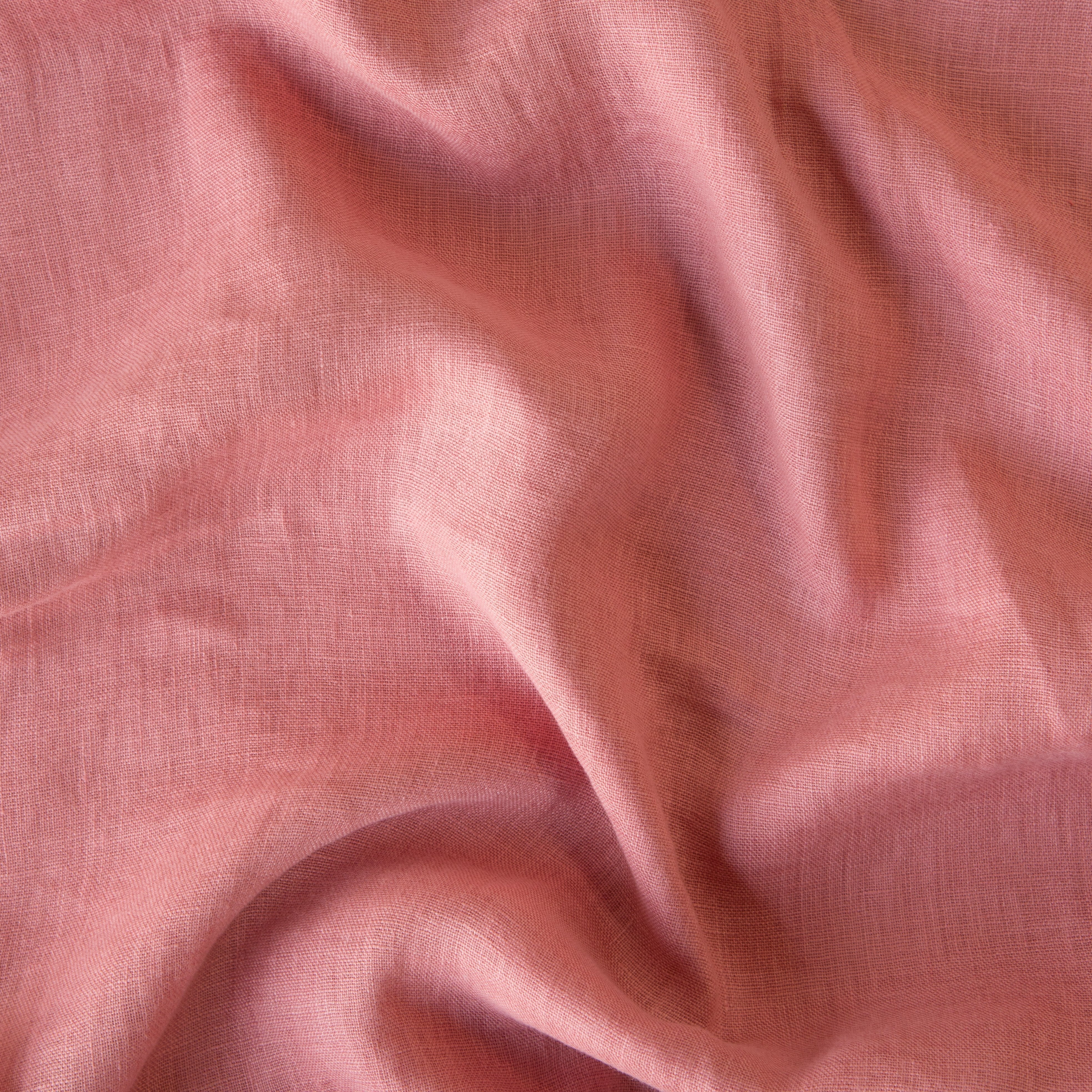 Poppy: A close up of linen whisper, our lightweight linen gauze, in poppy, a warm coral pink.