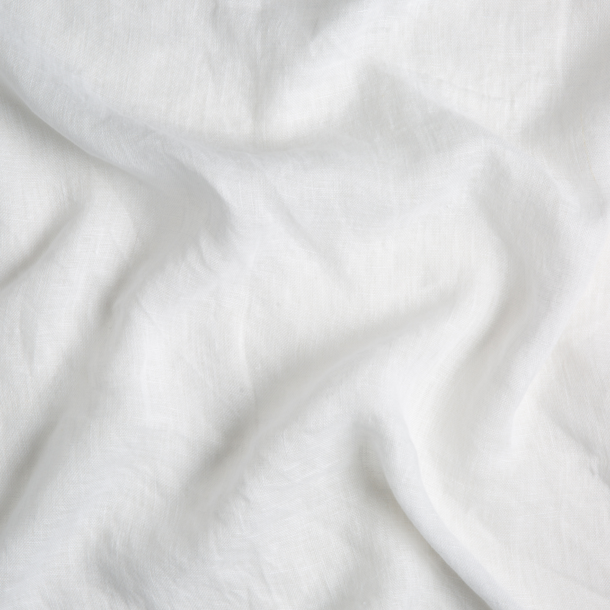 Winter White: A close up of linen whisper fabric in winter white, softer and warmer in tone than classic white.