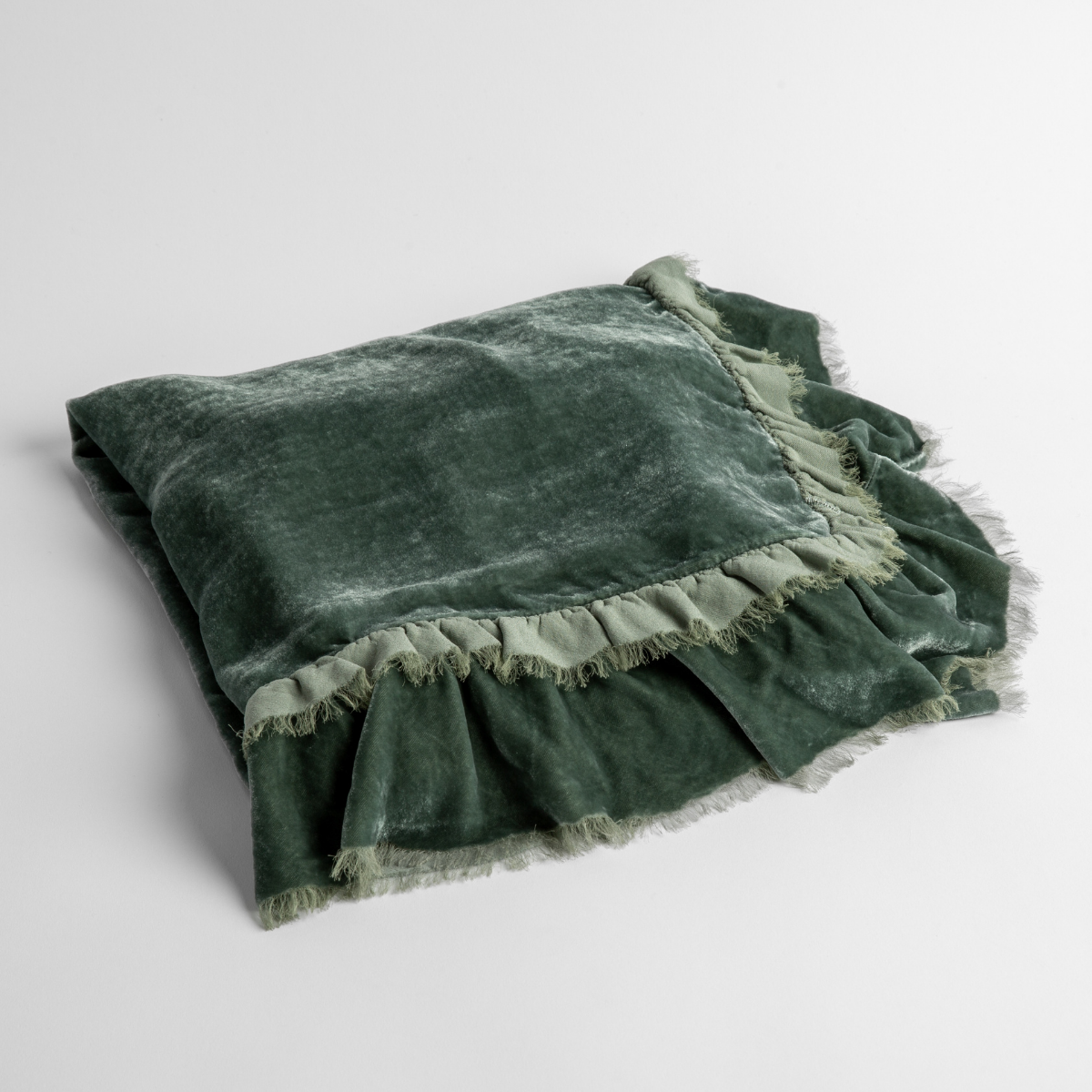 Eucalyptus: an overhead shot of a folded silk velvet baby blanket with a raw-edged eyelash ruffle detail.