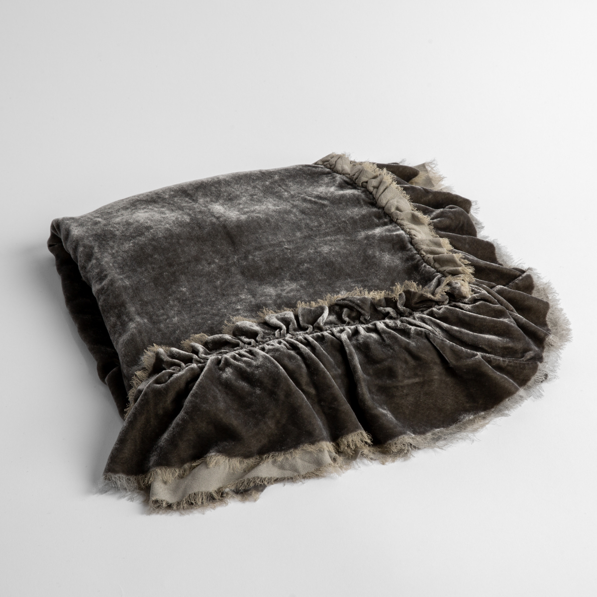 Fog: an overhead shot of a folded silk velvet baby blanket with a raw-edged eyelash ruffle detail.