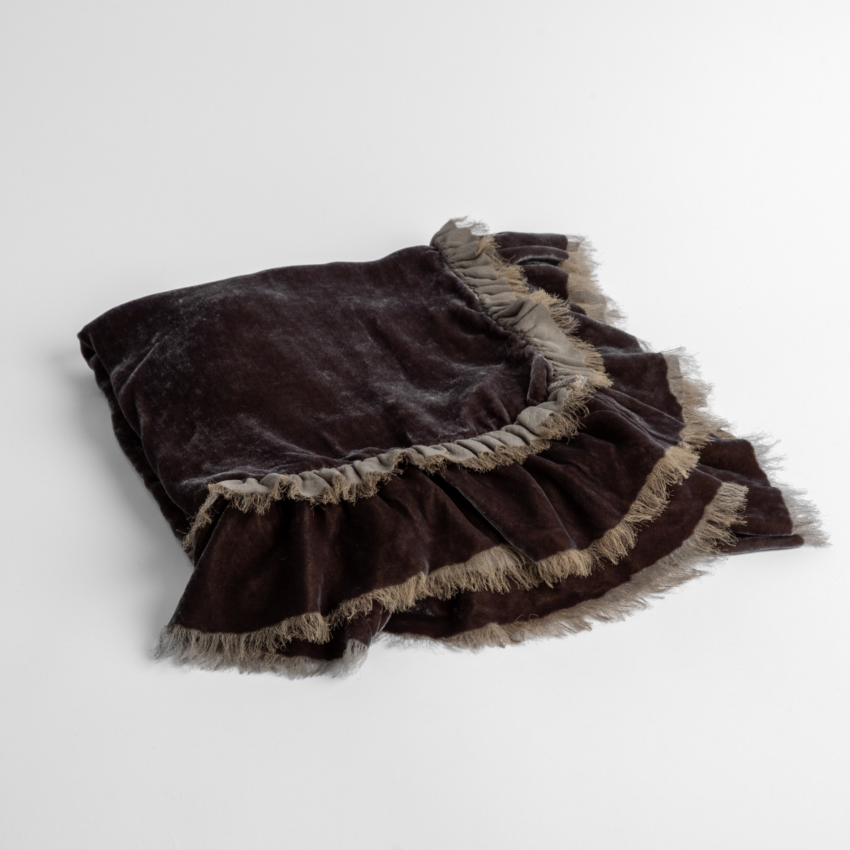 Moonlight: an overhead shot of a folded silk velvet baby blanket with a raw-edged eyelash ruffle detail.