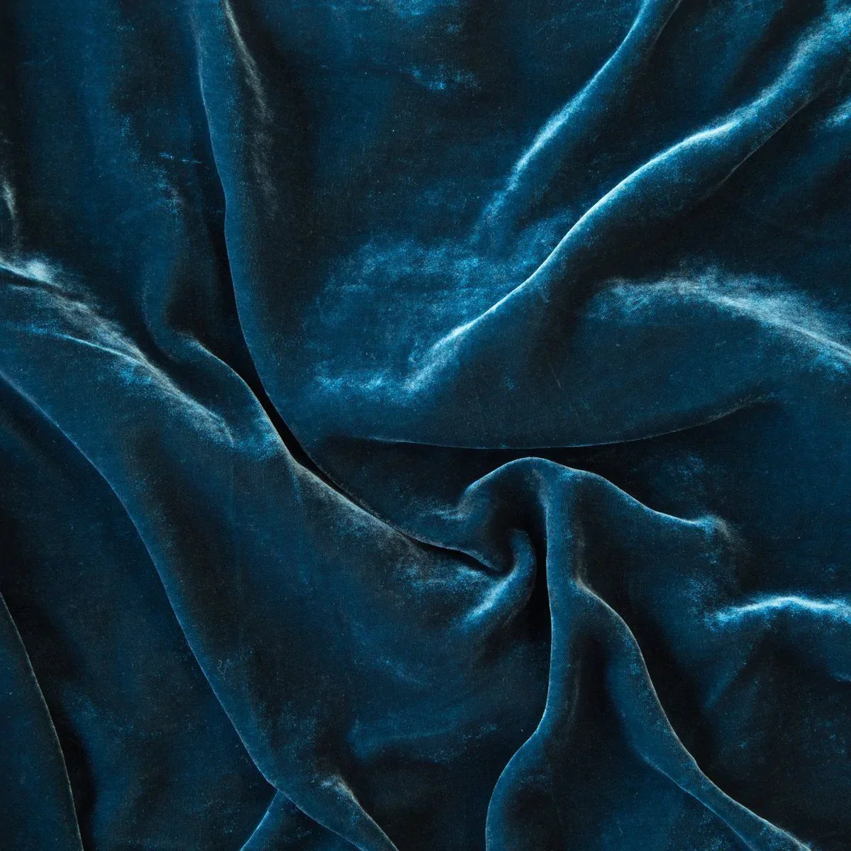 Cenote: A close up of silk velvet in cenote, a vibrant, ocean-inspired blue-green.