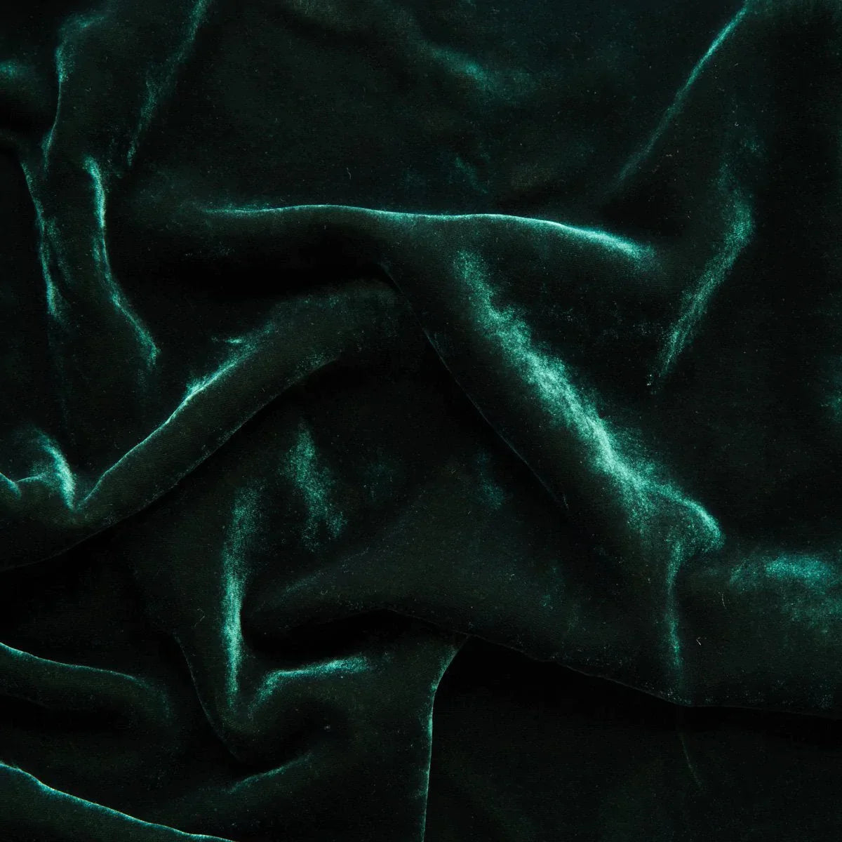 Jade: A close up of silk velvet in jade, a rich, verdant green with subtle blue undertones.
