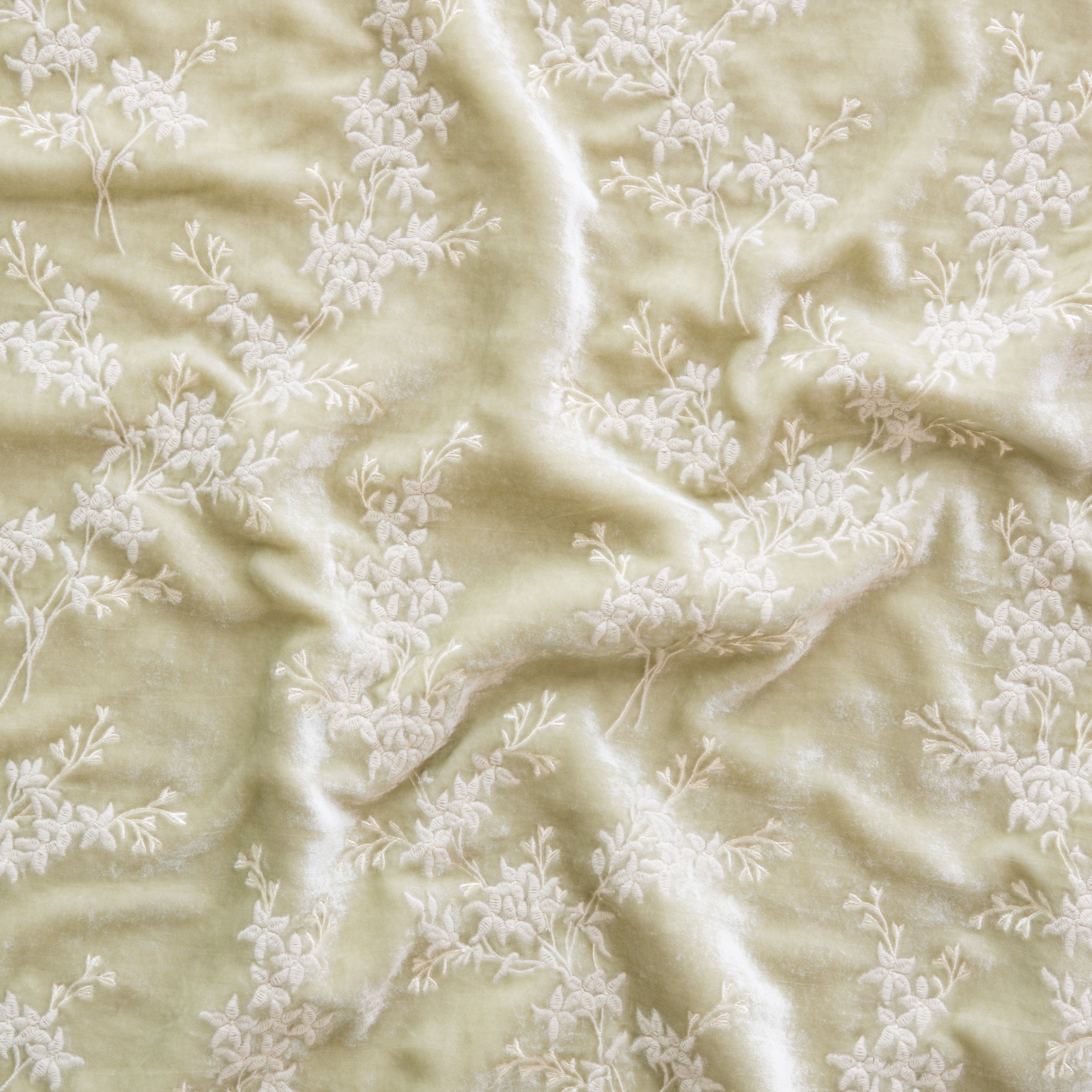 Parchment: A close up of Lynette embroidered silk velvet, in parchment, a warm, antiqued cream.