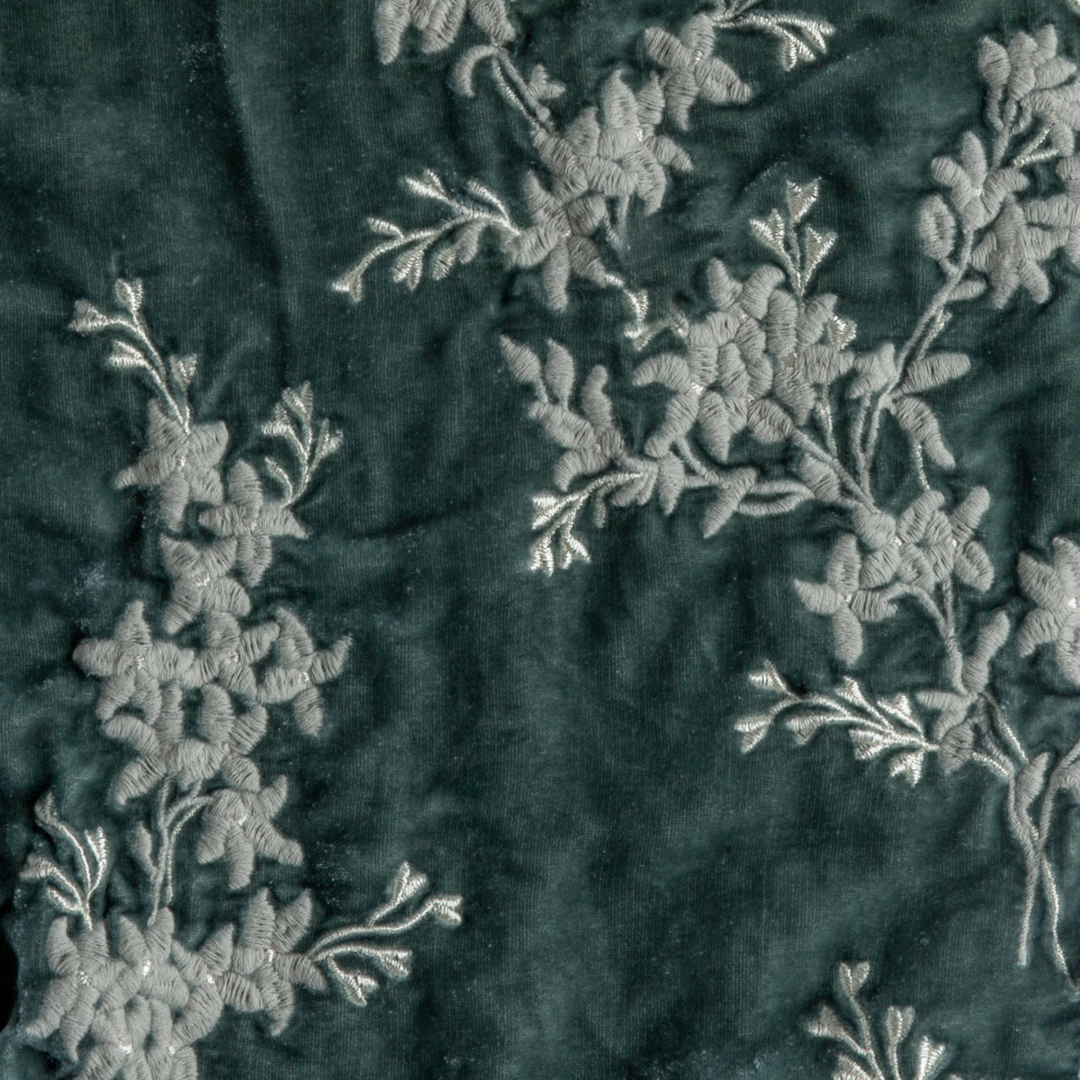 Eucalyptus: A close up of embroidered silk velvet fabric in eucalyptus, a soft light green.
