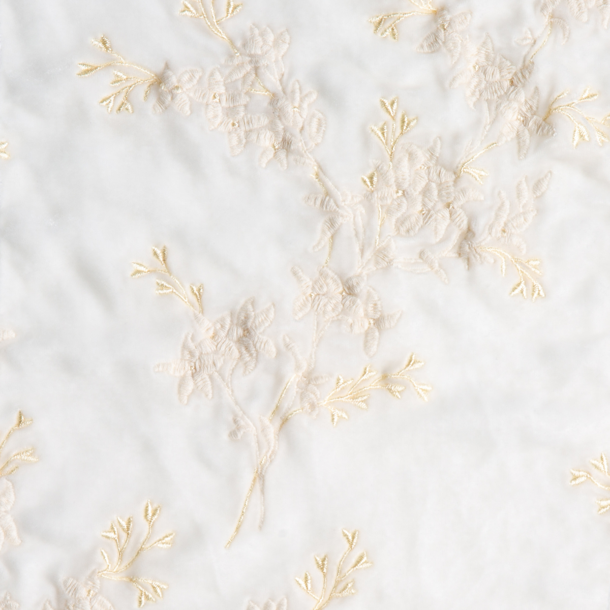 Winter White: A close up of embroidered silk velvet fabric in winter white, softer and warmer in tone than classic white.
