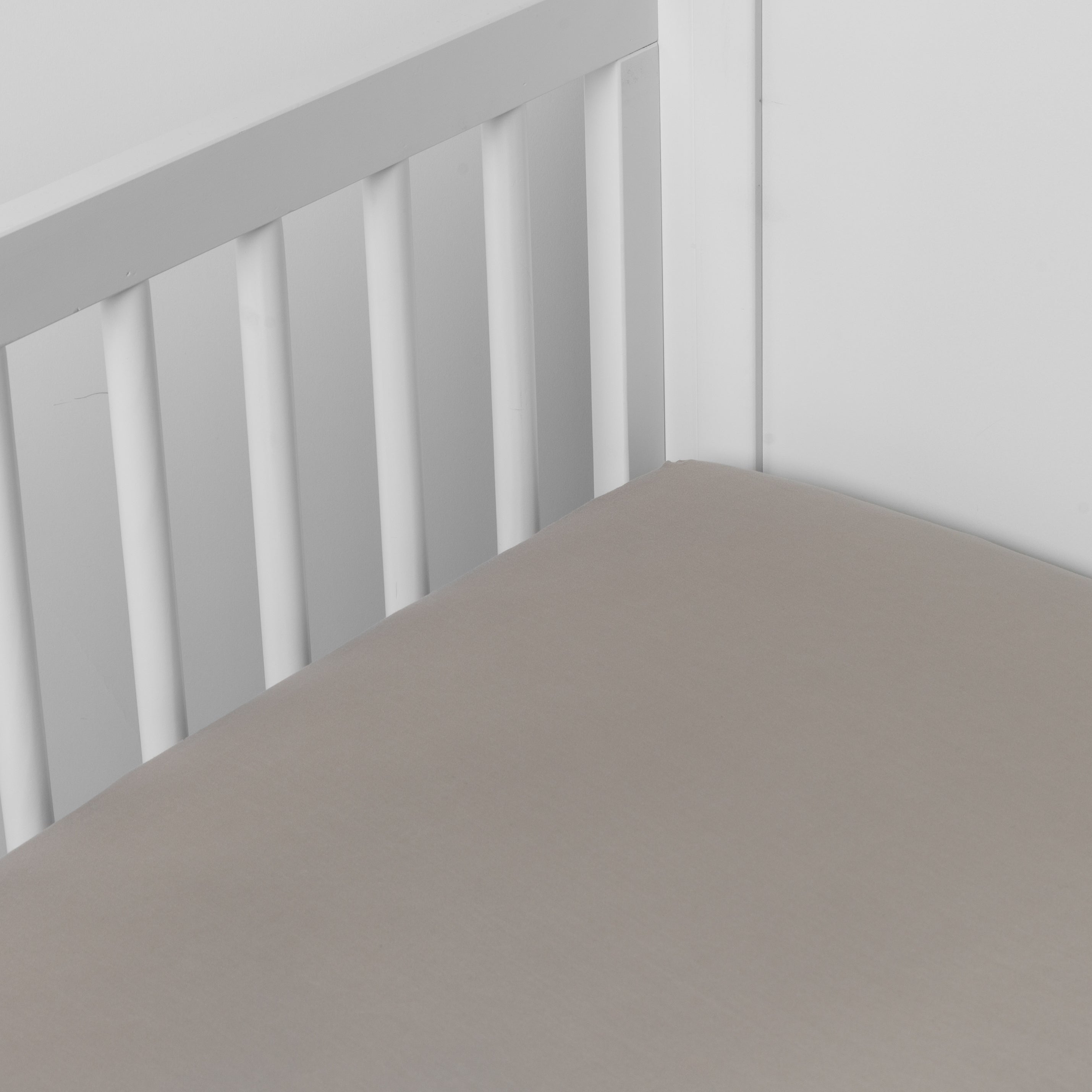 Fog: crib sheet shown on a mattress shown from overhead into the corner of a crib.