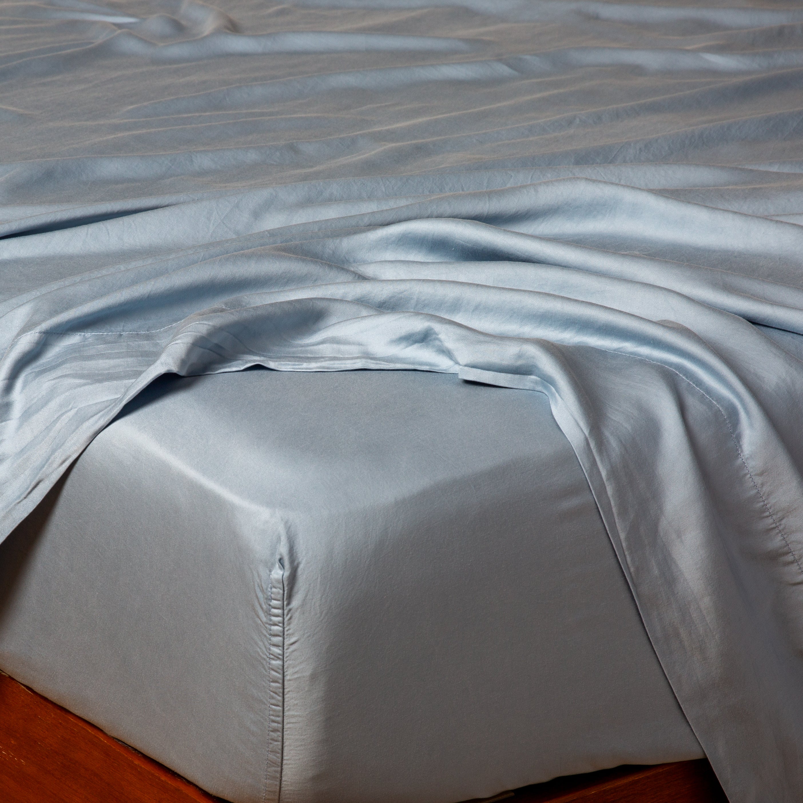 Tahoe Blue: tencel™ fitted sheet on a mattress with a matching flat sheet.