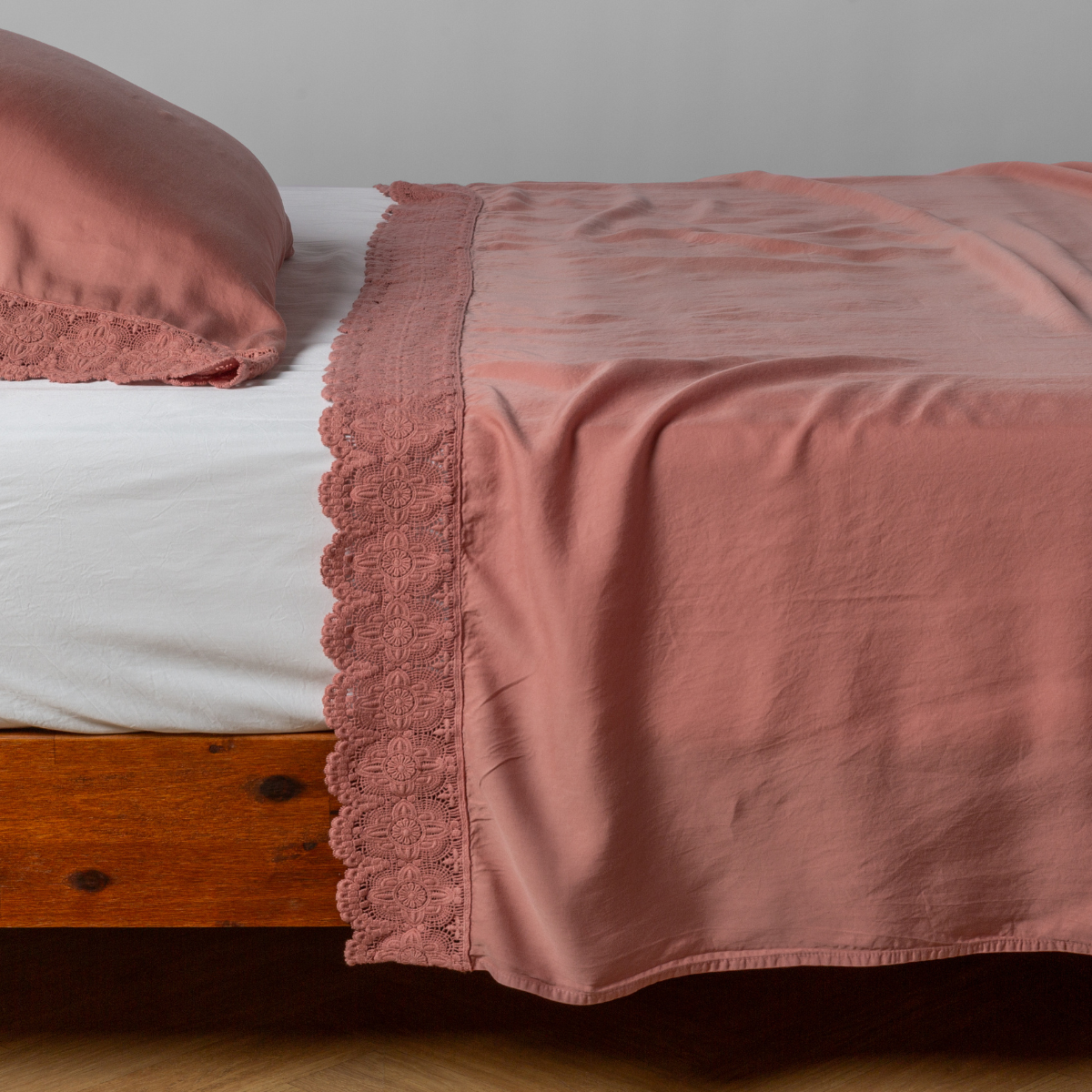 matching cotton lace trimmed flat sheet and pillowcase shown with simple white sheet - side view.