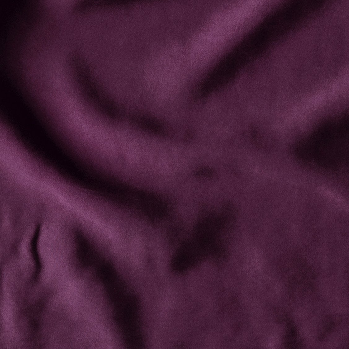 Fig: A close up of Tencel™ fabric in fig, a richly saturated purple-garnet.