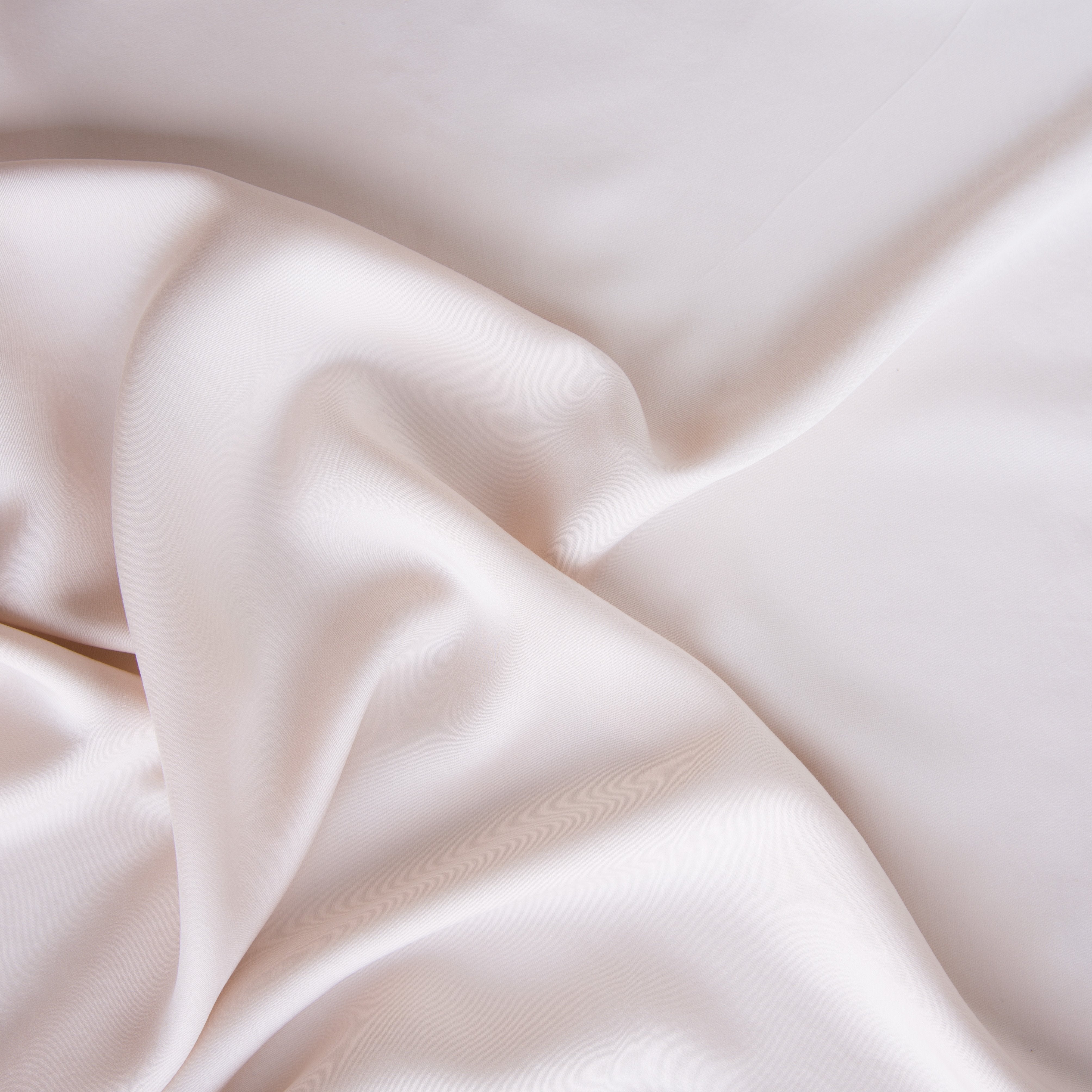Pearl: A close up of Tencel™ fabric in pearl, a nude-like, soft rose pink tone.