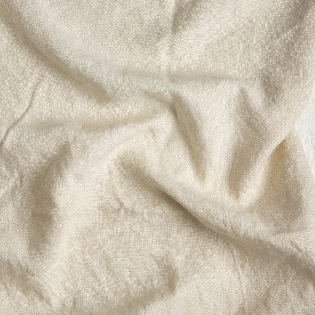 Parchment: A close up of midweight linen fabric in parchment, a warm, antiqued cream.
