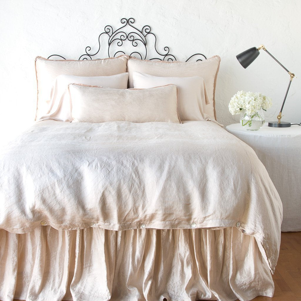 Pearl: duvet cover with matching pillows and bed skirt - end of bed view.