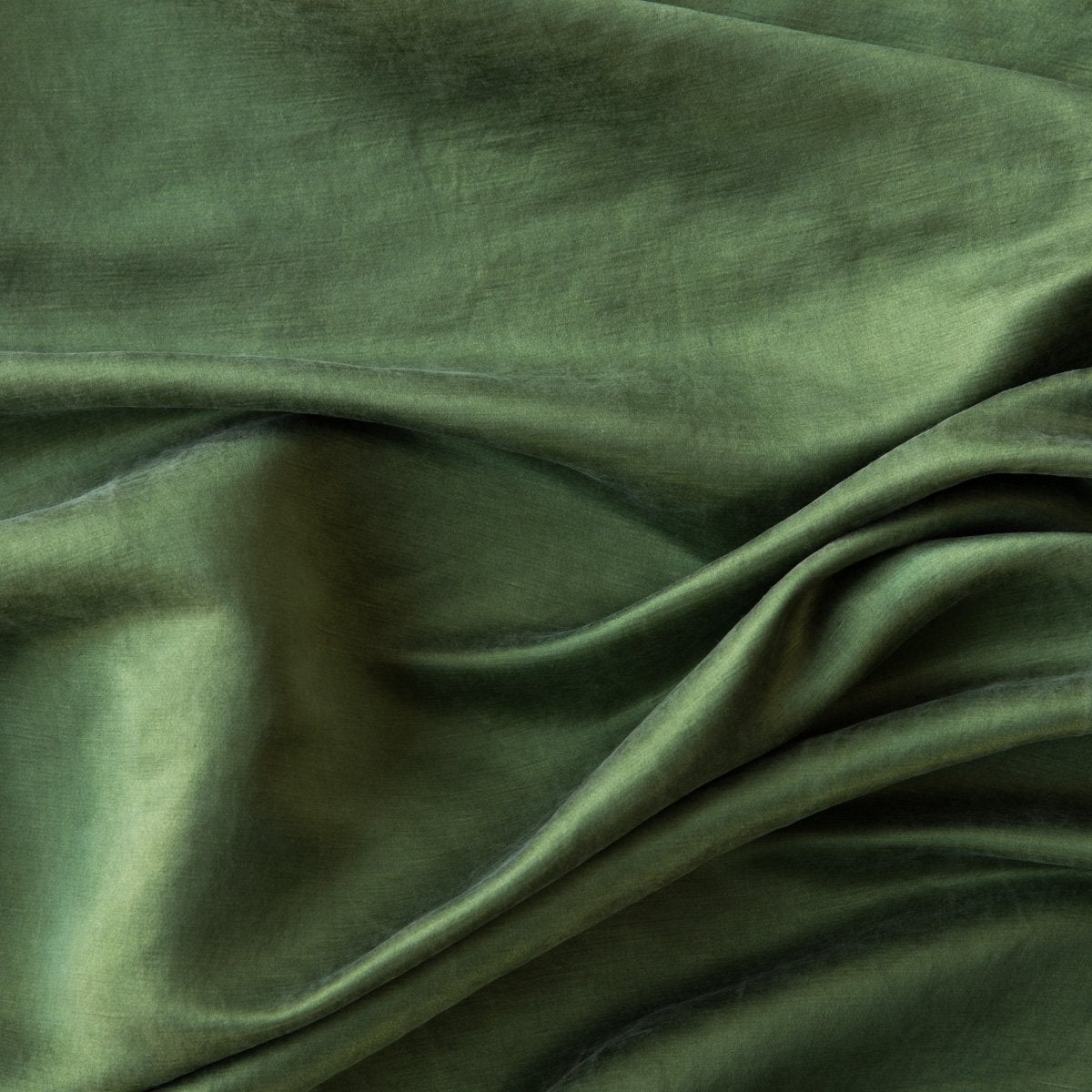 Close-up of silk charmeuse in jade, a rich, verdant green with subtle blue undertones.