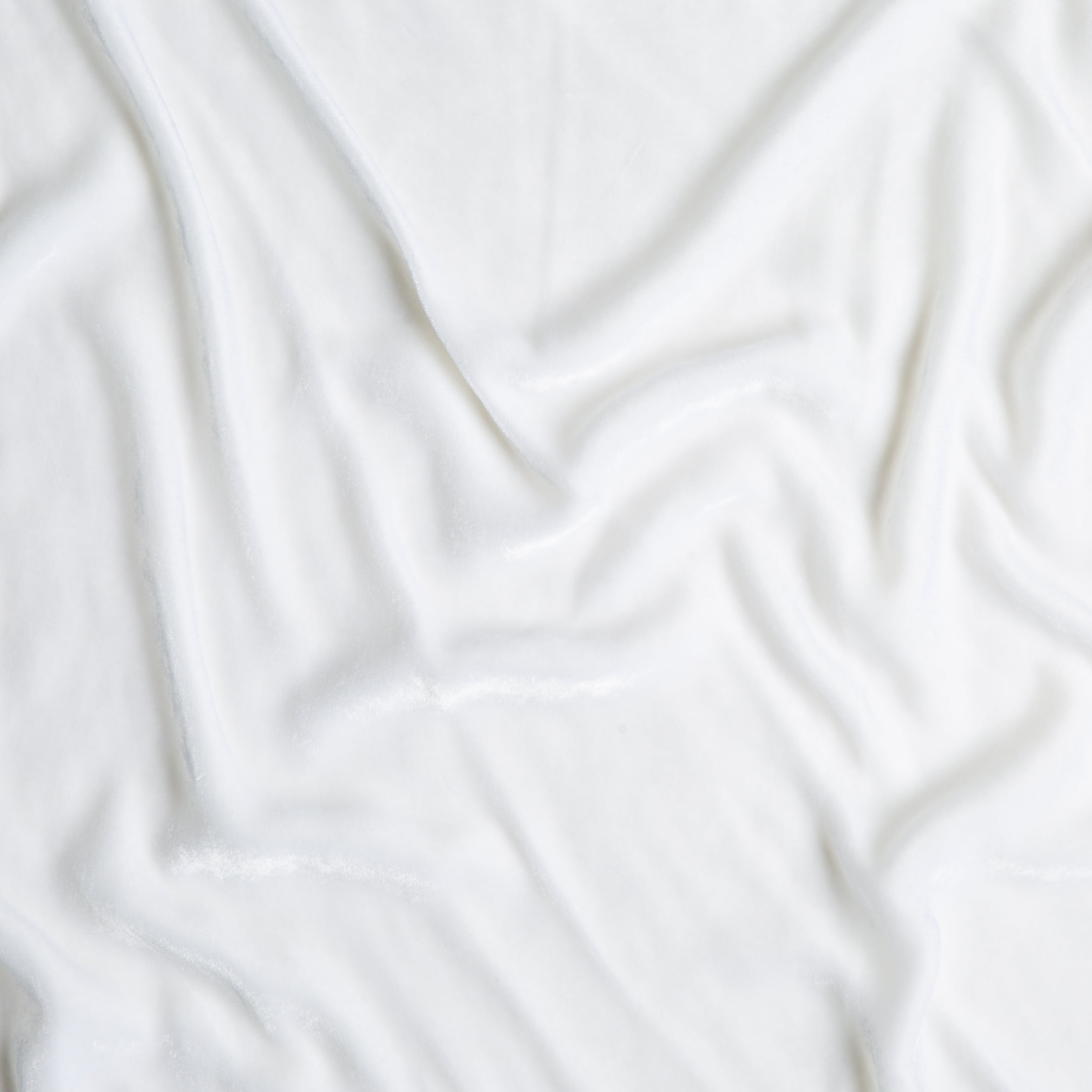 White: A close up of silk velvet fabric in classic white.
