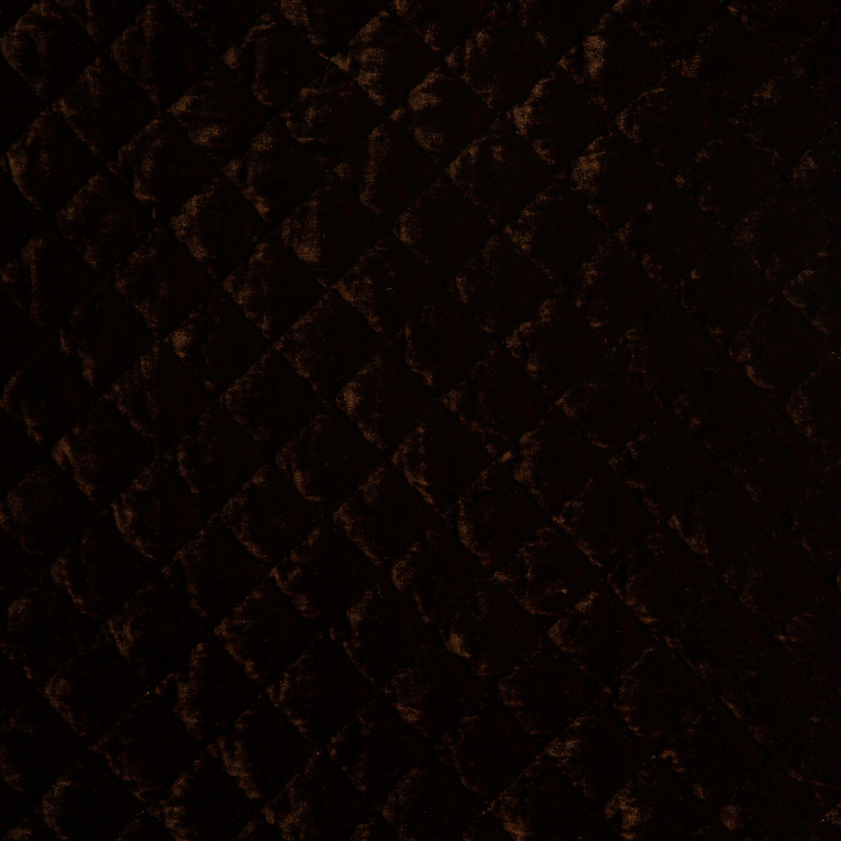 Close-up of quilted silk velvet in mahogany, a deep, earthen, reddish brown.