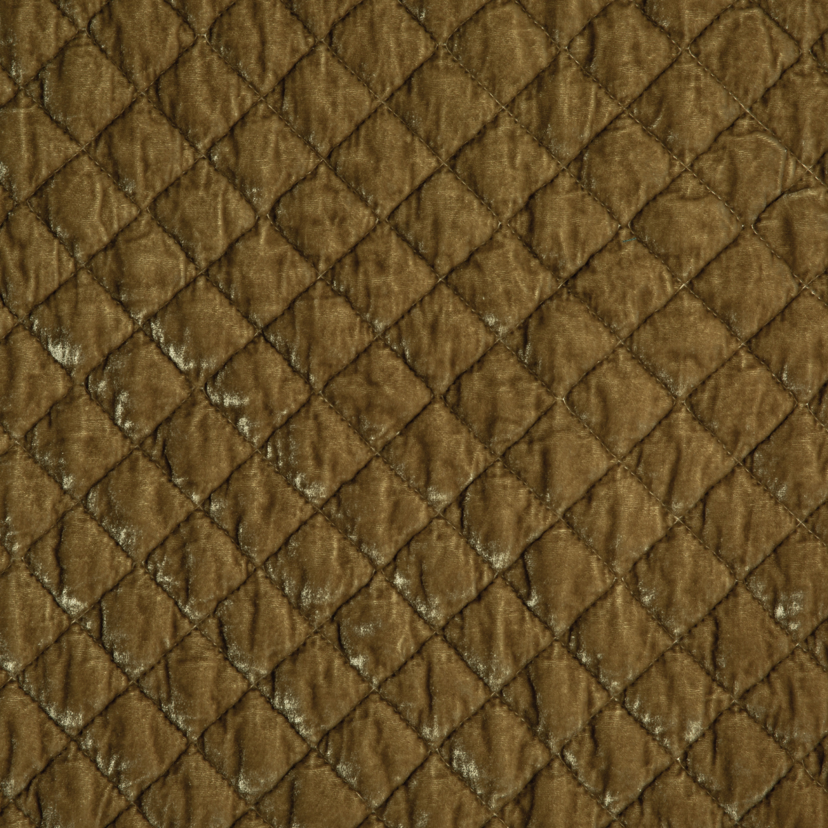 Honeycomb: A close up of quilted silk velvet fabric in honeycomb, a warm golden tone.