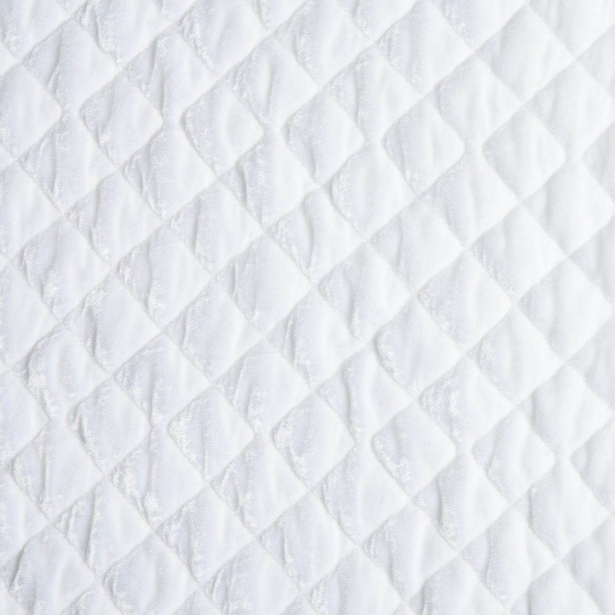 White: A close up of quilted silk velvet fabric in classic white.
