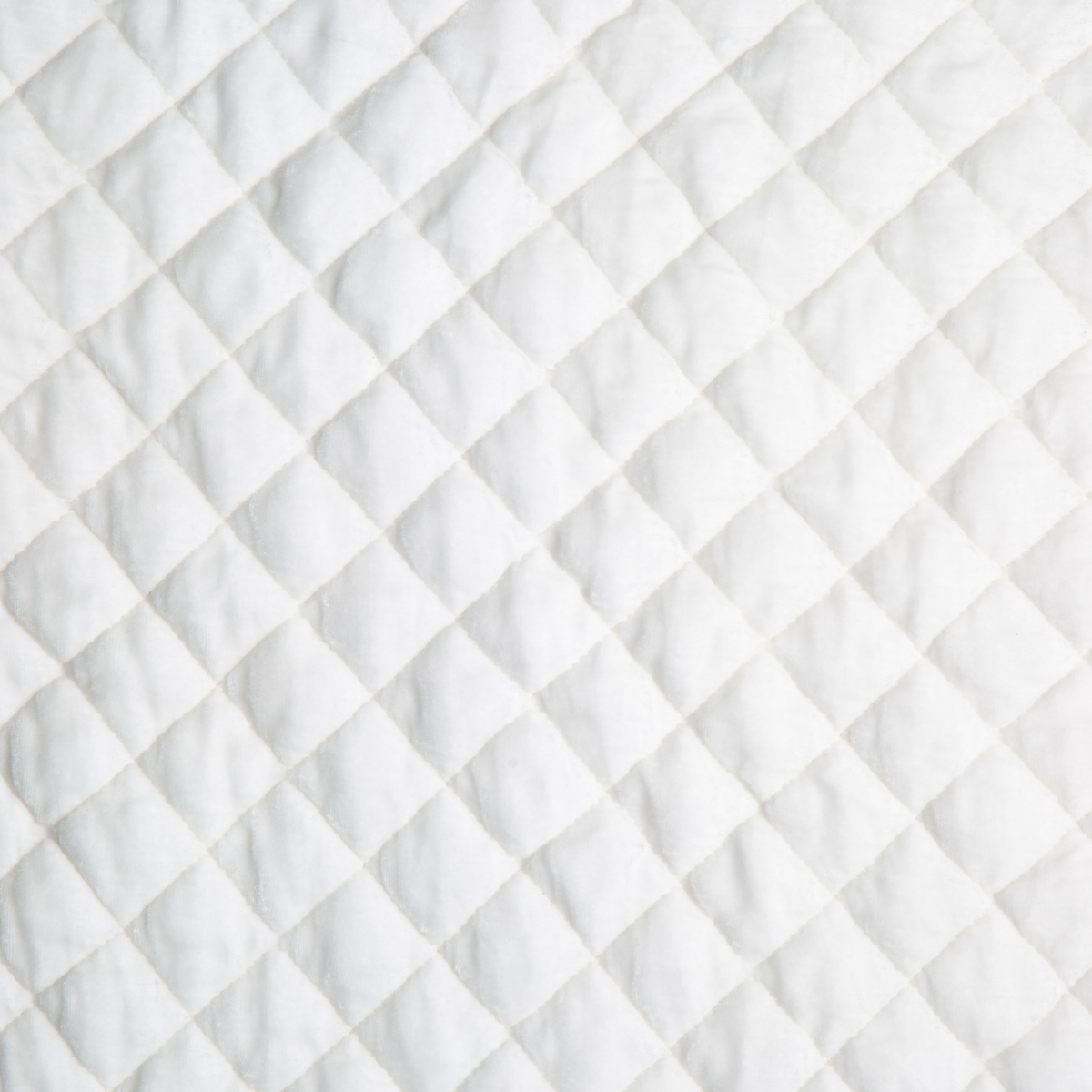 Winter White: A close up of quilted silk velvet fabric in winter white, softer and warmer in tone than classic white.