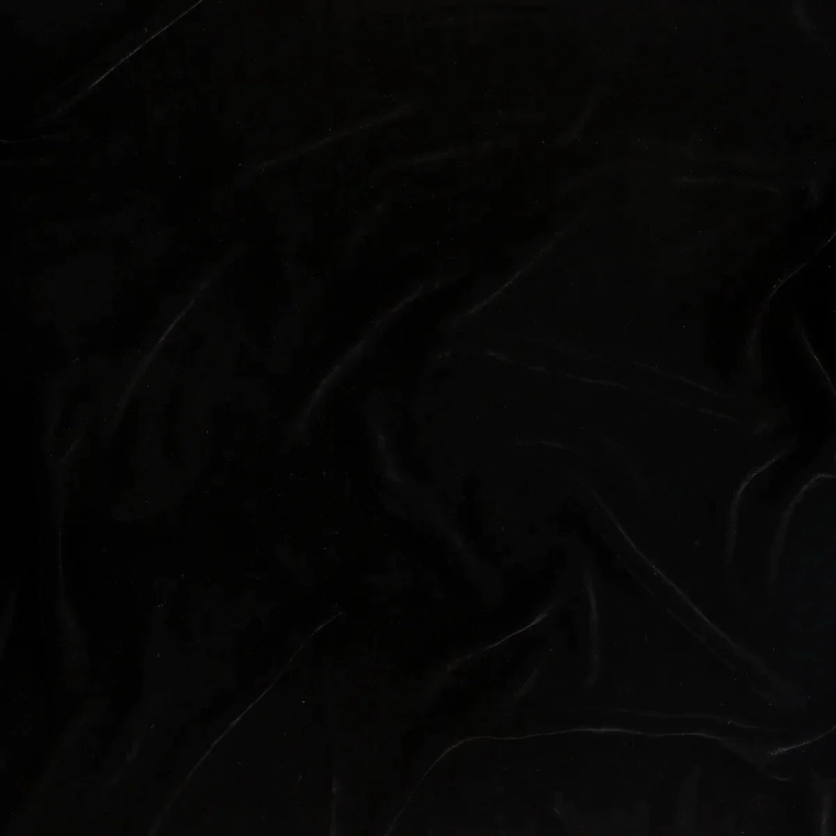 Corvino: A close up of silk velvet fabric in Corvino, a black tone