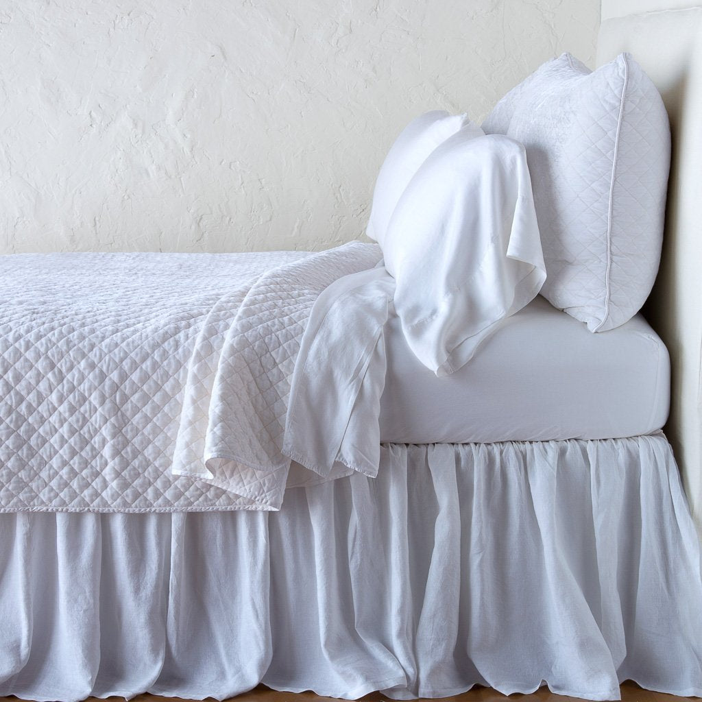 White: coverlet with matching shams and white sheeting - side view.