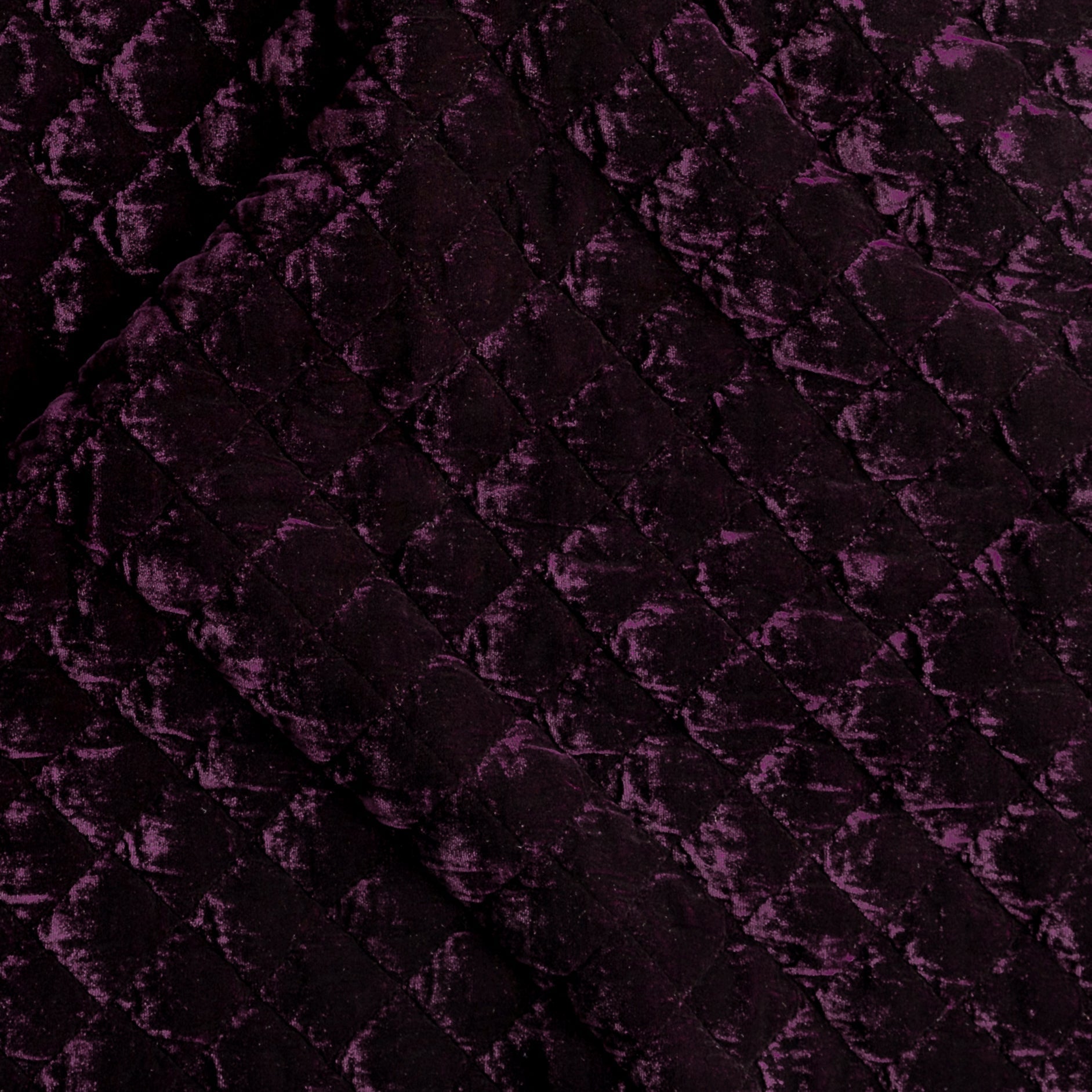 Fig: Close-up of quilted silk velvet in fig, a richly saturated purple-garnet.