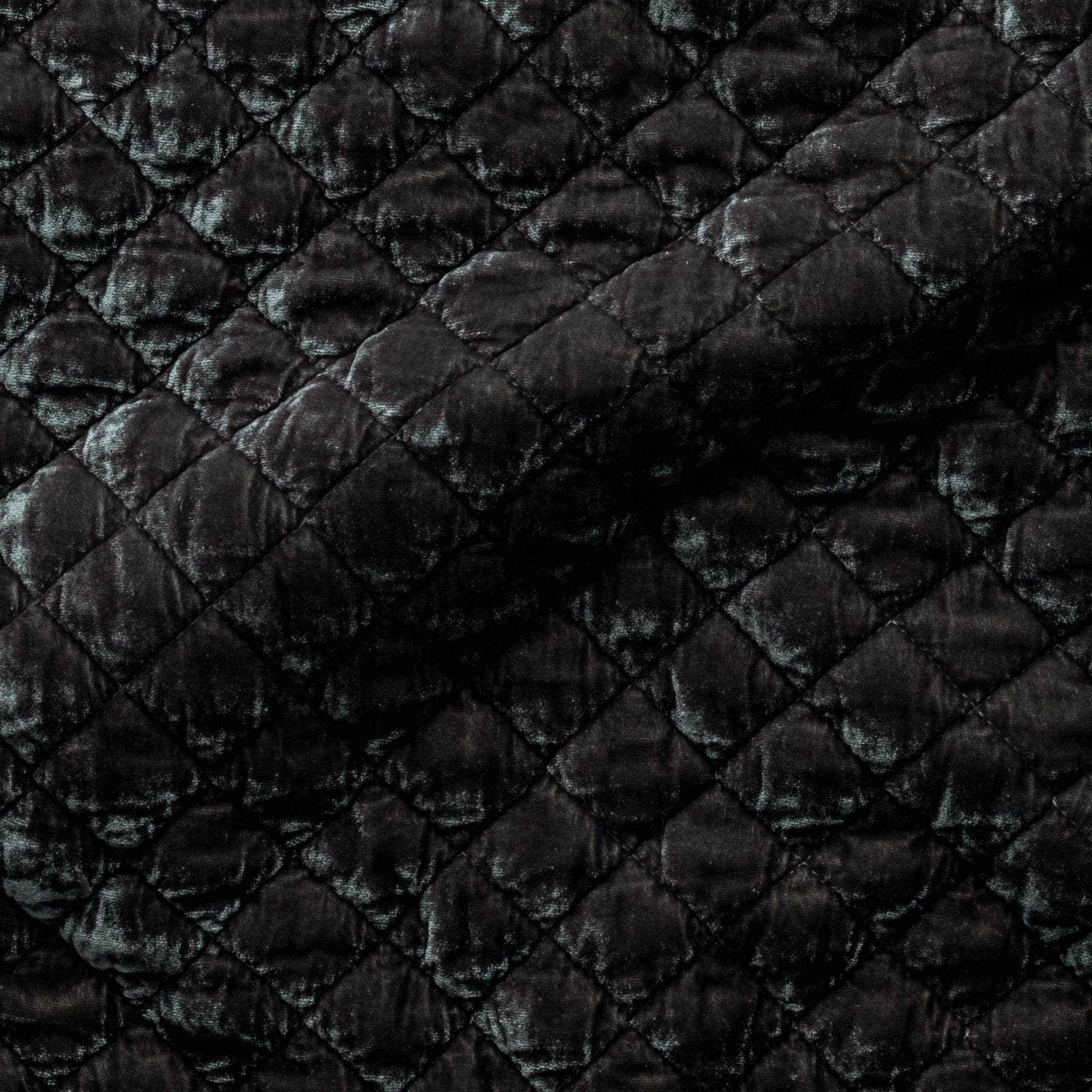 Moonlight: Close-up of quilted silk velvet in moonlight, a saturated, cool, mid-dark grey tone.